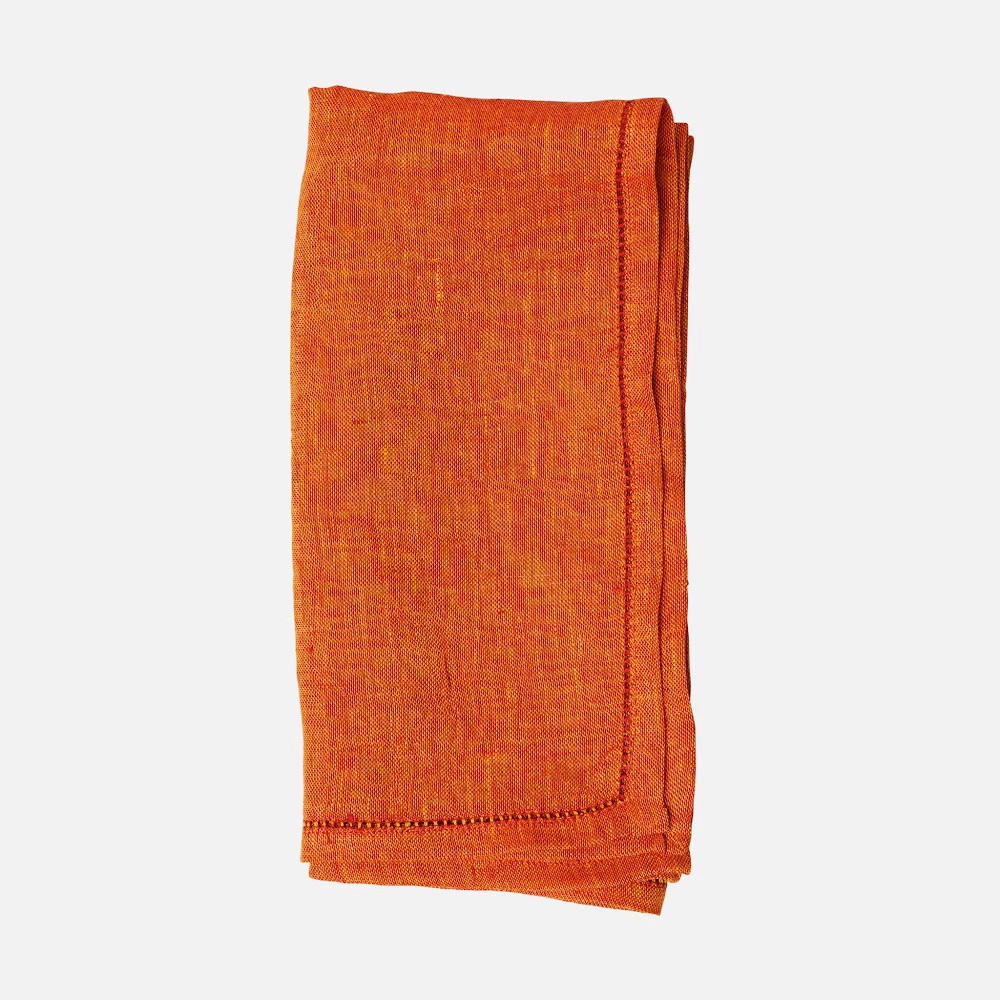 an orange scarf is folded on a white background