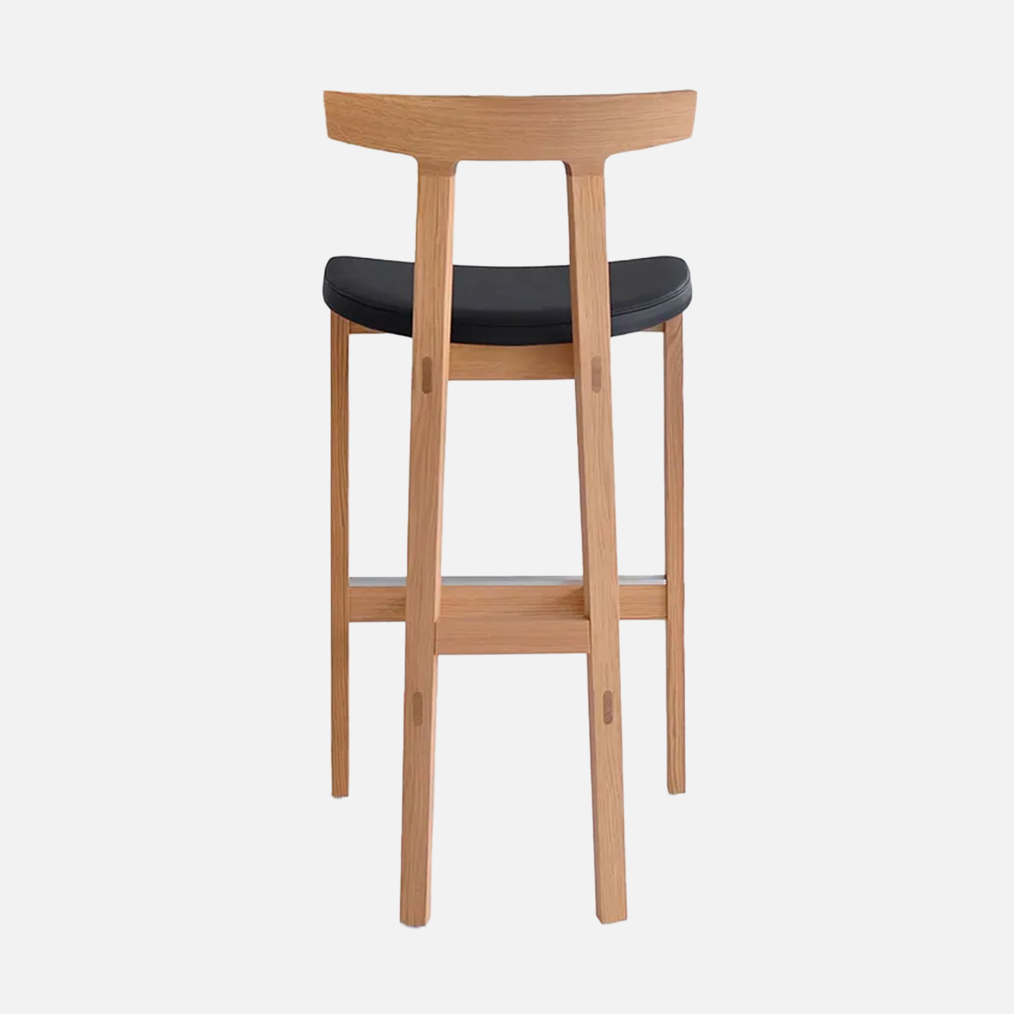 a wooden bar stool with a black seat