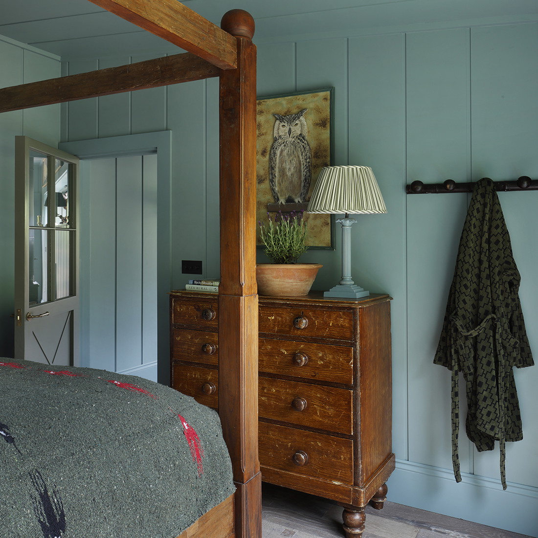 a bed room with a neatly made bed and a night stand