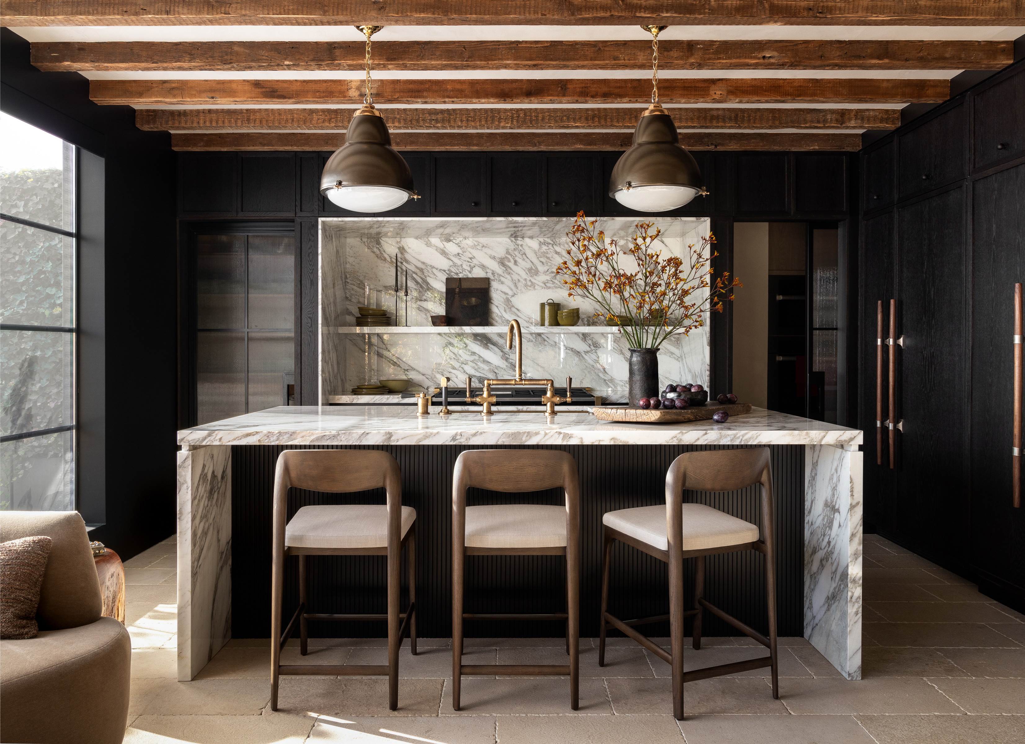 a kitchen with a marble counter top and bar stools