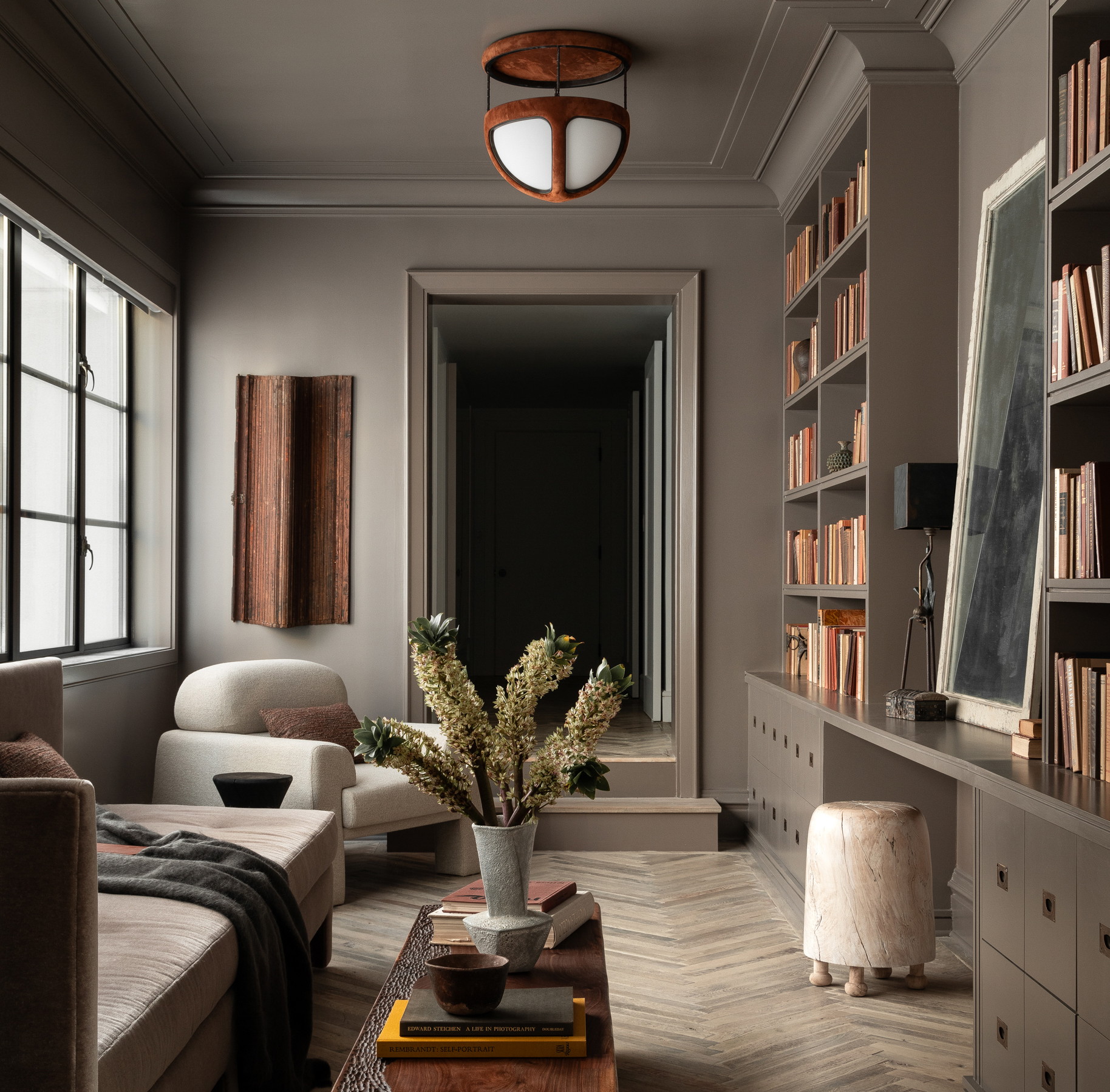 a living room filled with furniture and a book shelf