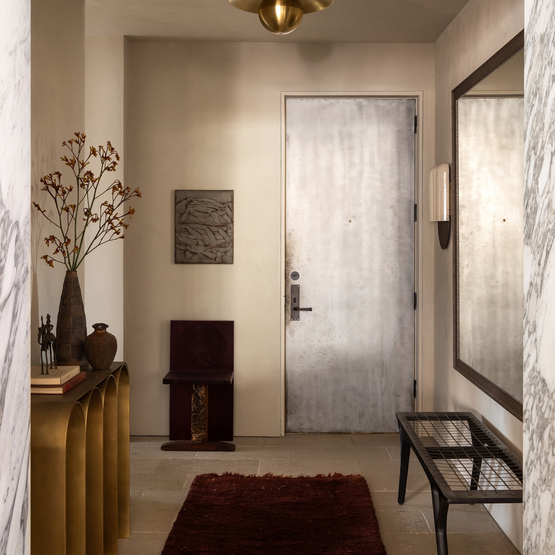 a hallway with a red rug and a white door