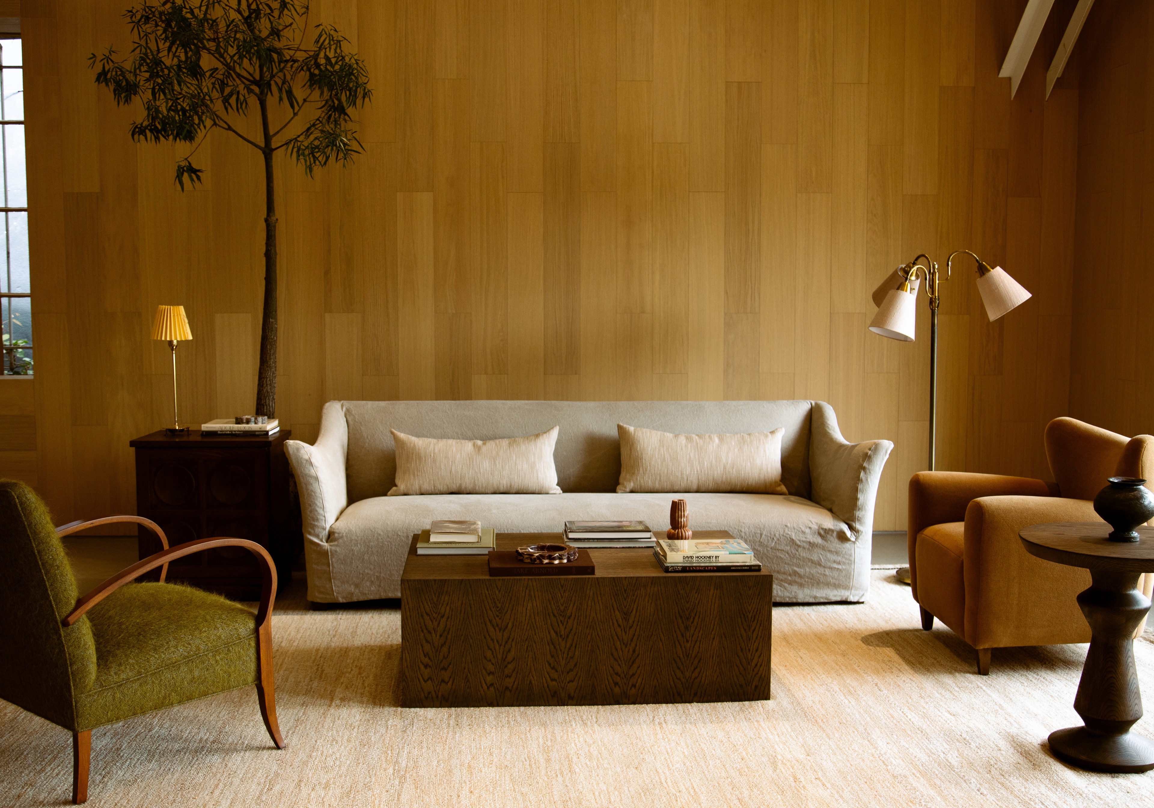 a living room filled with furniture and a tree