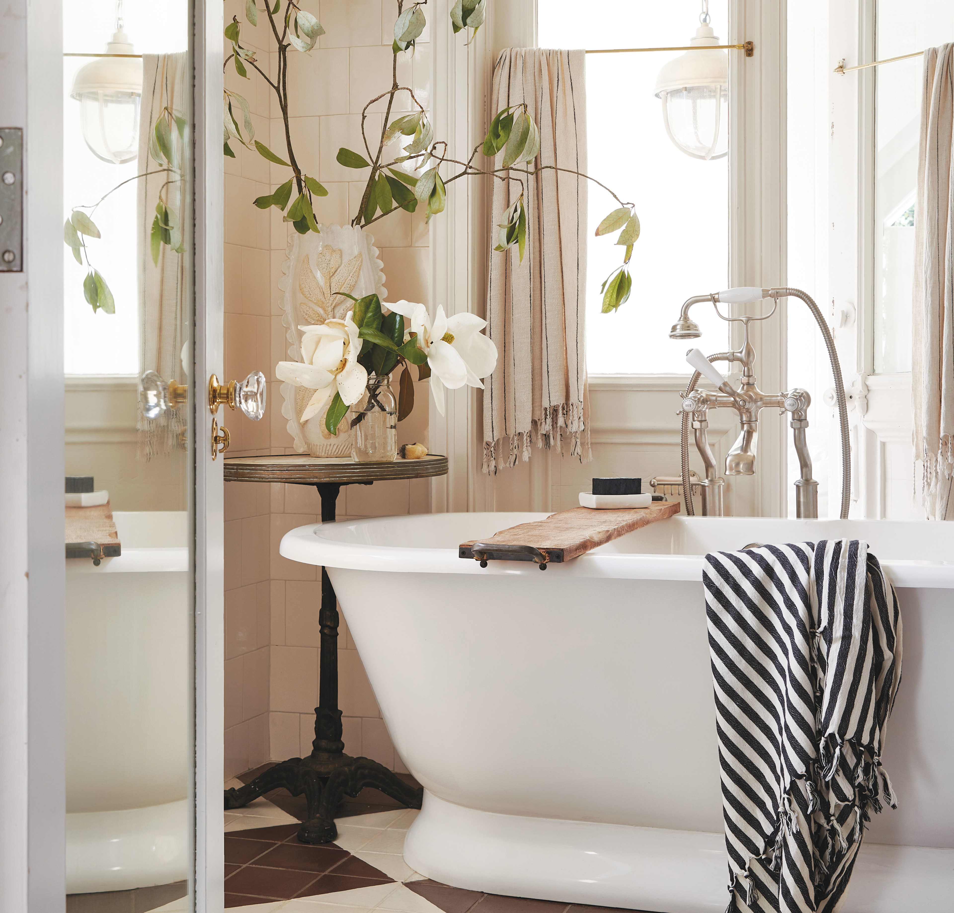 a bathroom with a checkered floor and a claw foot tub