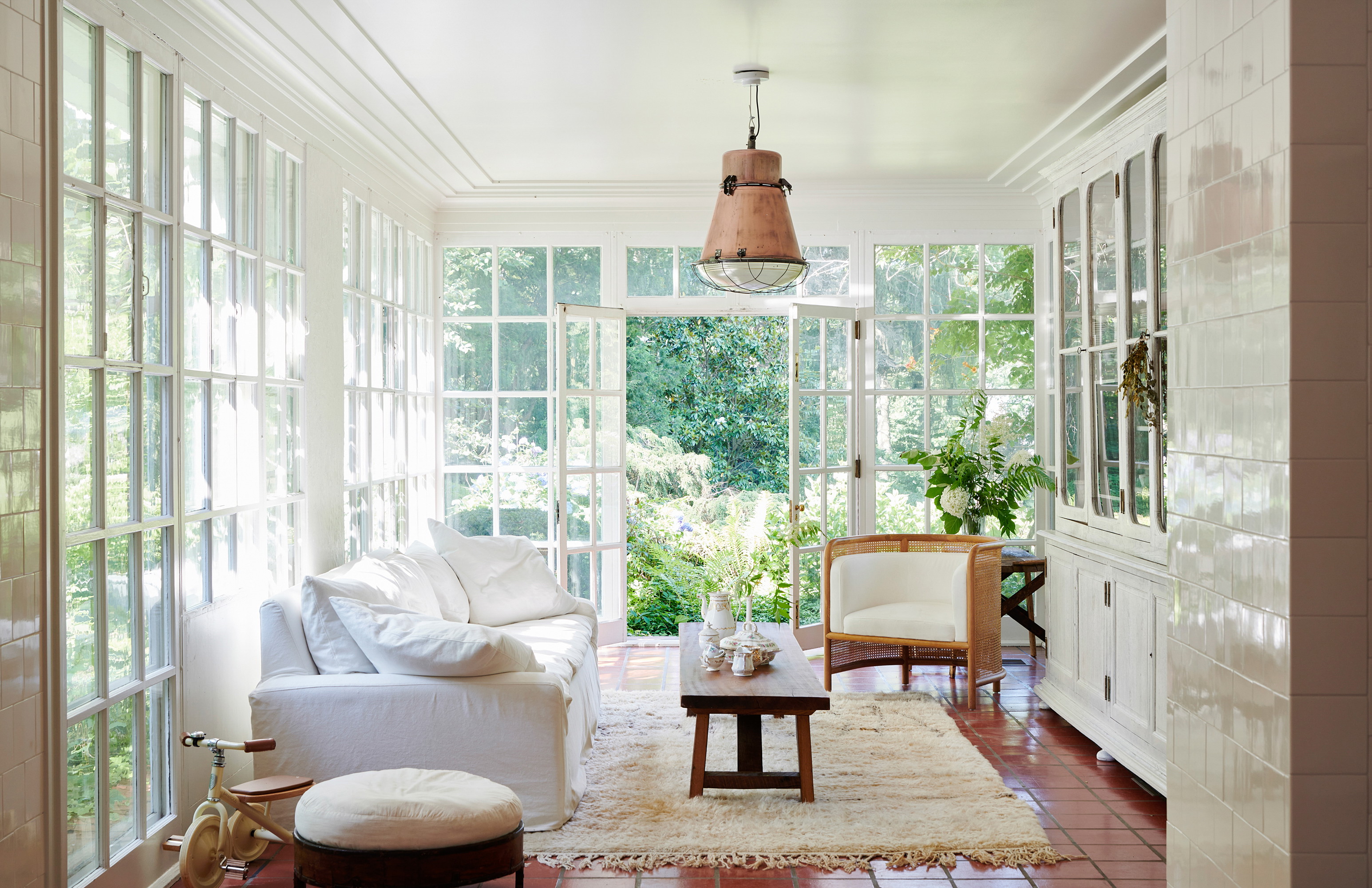 a living room filled with furniture and lots of windows