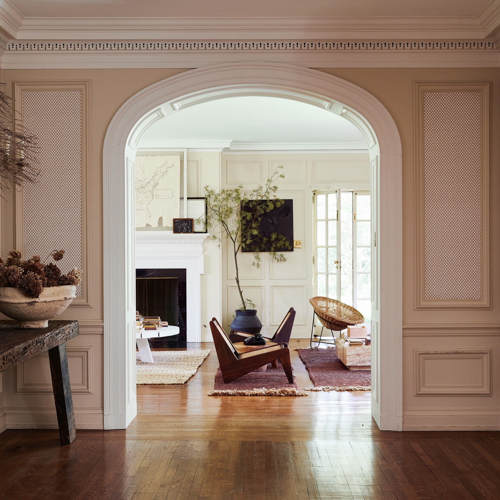 a living room with a wooden floor and a fireplace