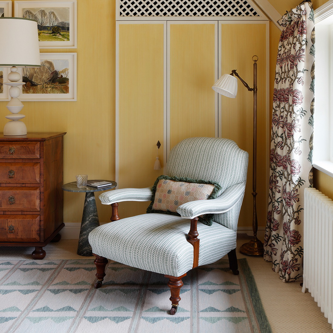 a chair and ottoman in a room with yellow walls