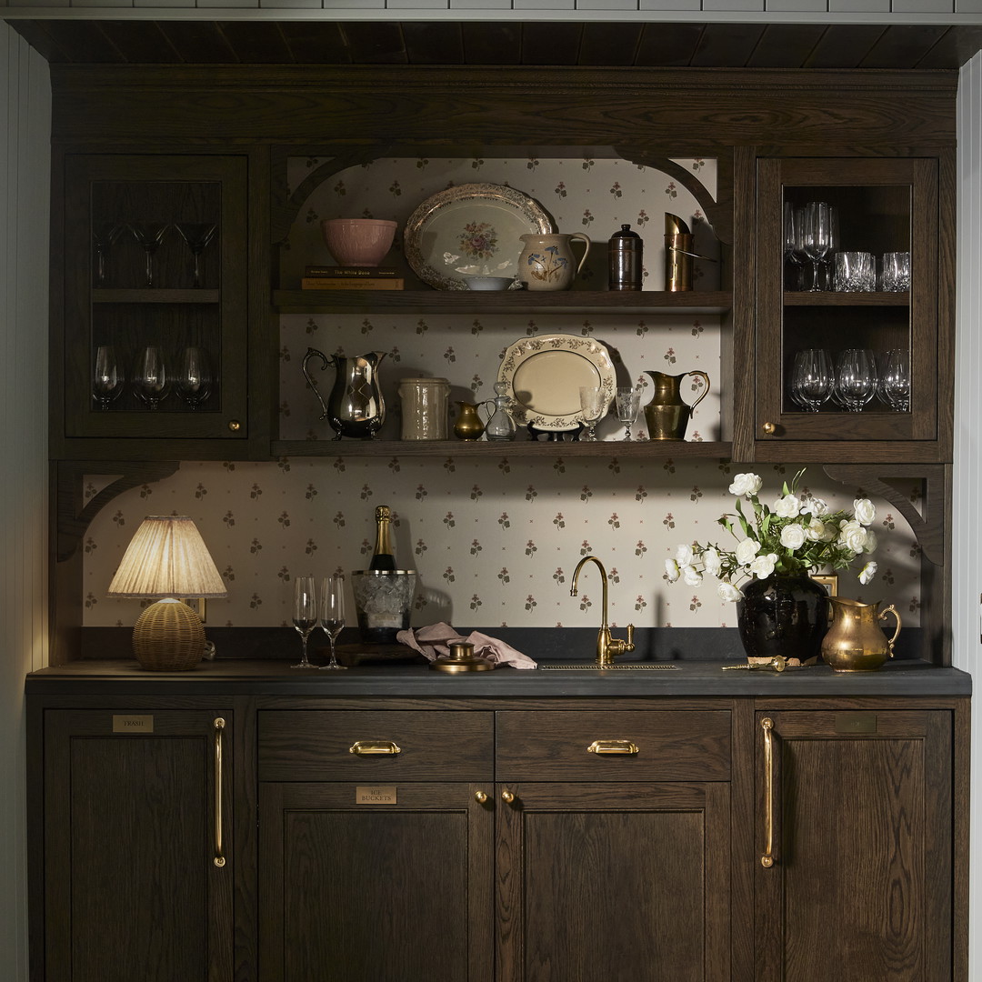 a kitchen with wooden cabinets and a black counter top