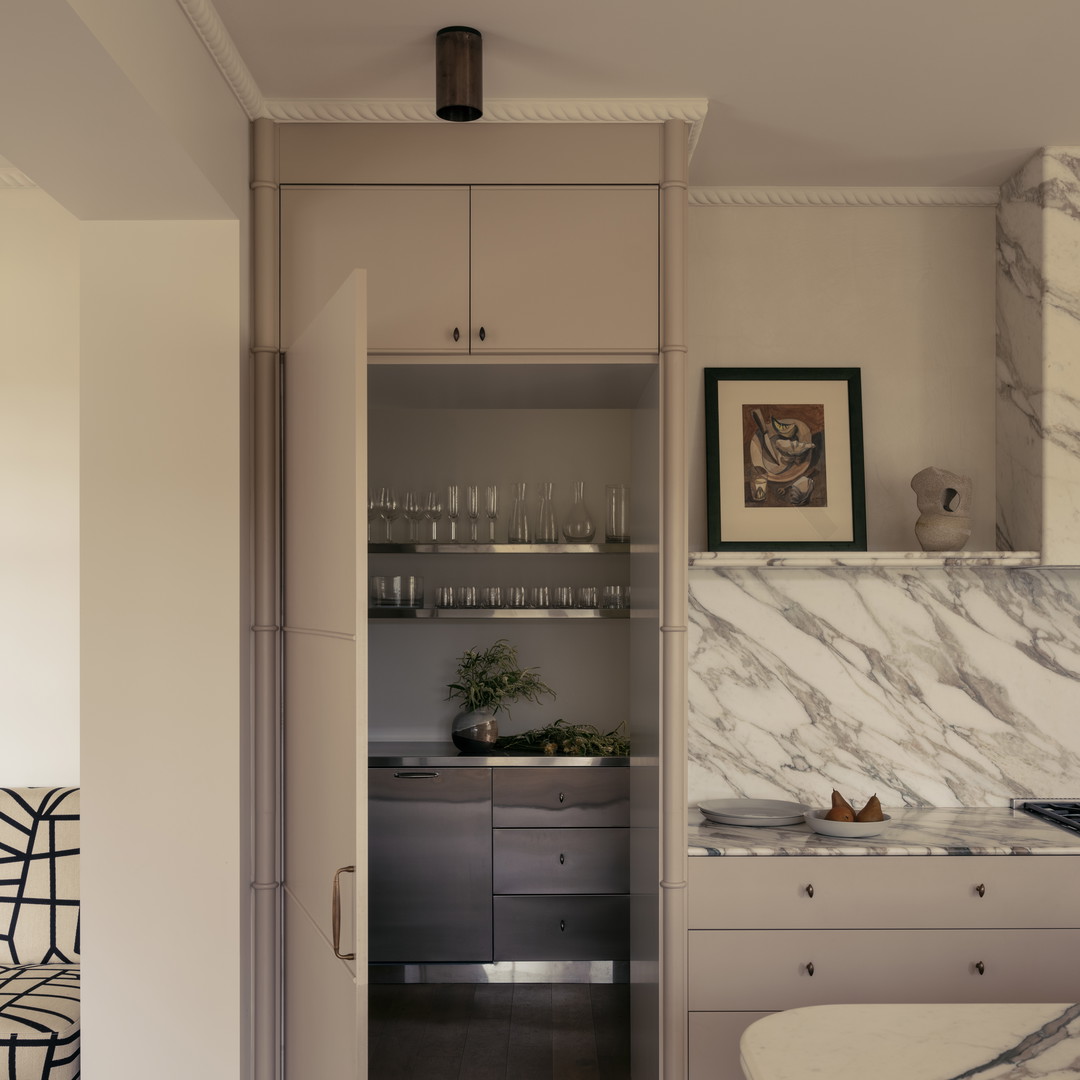 a kitchen with marble counter tops and cabinets