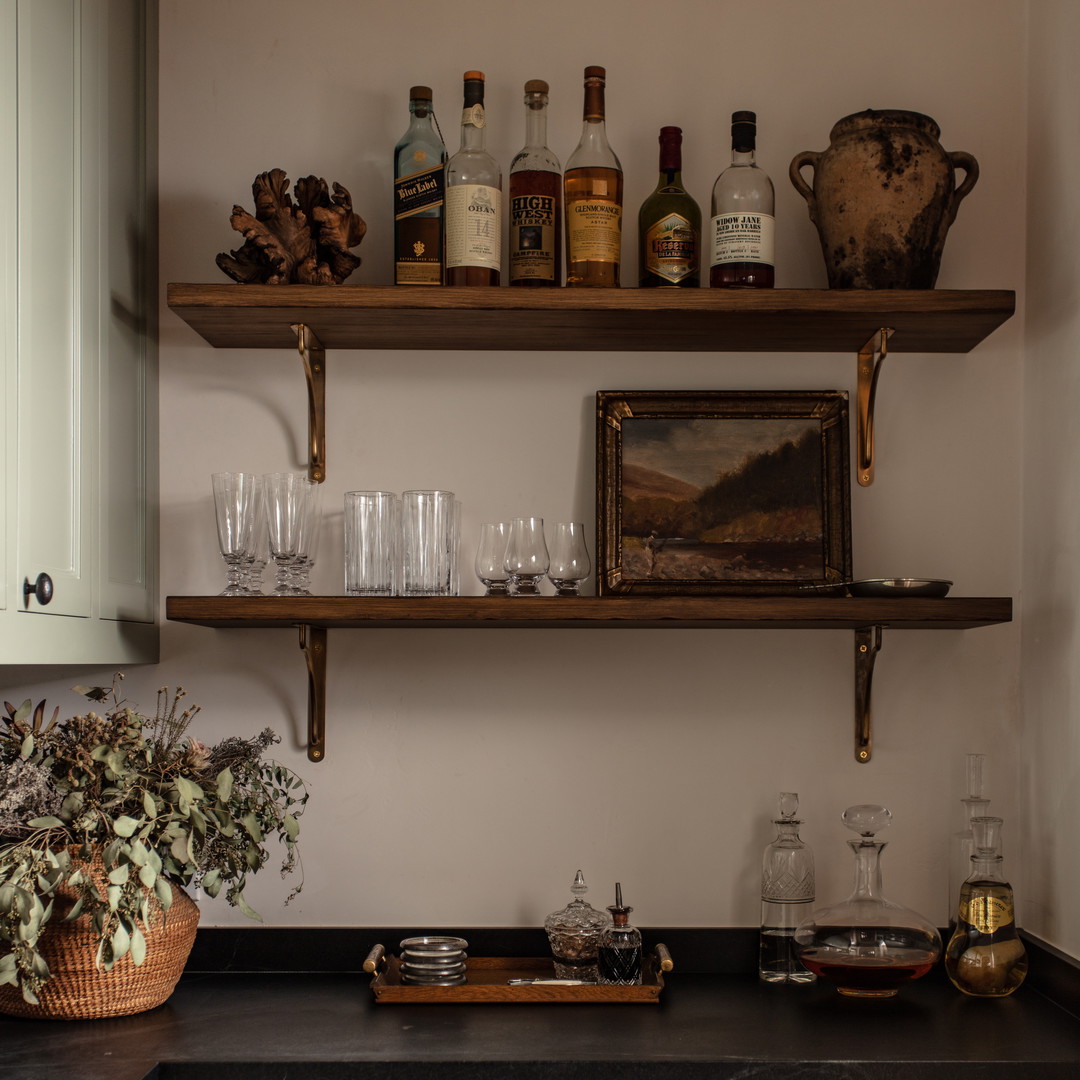 a kitchen filled with lots of bottles and glasses