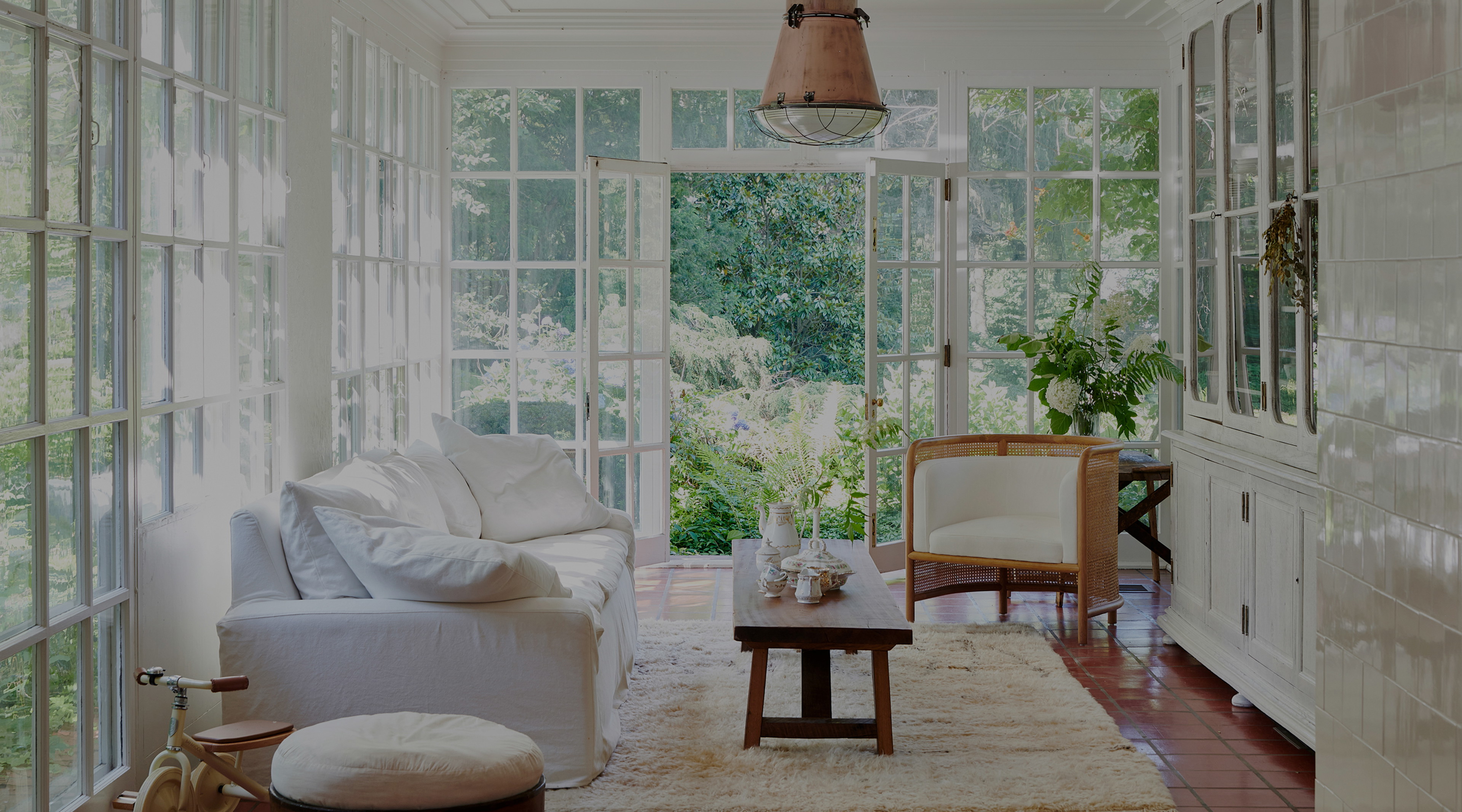 a living room filled with furniture and lots of windows