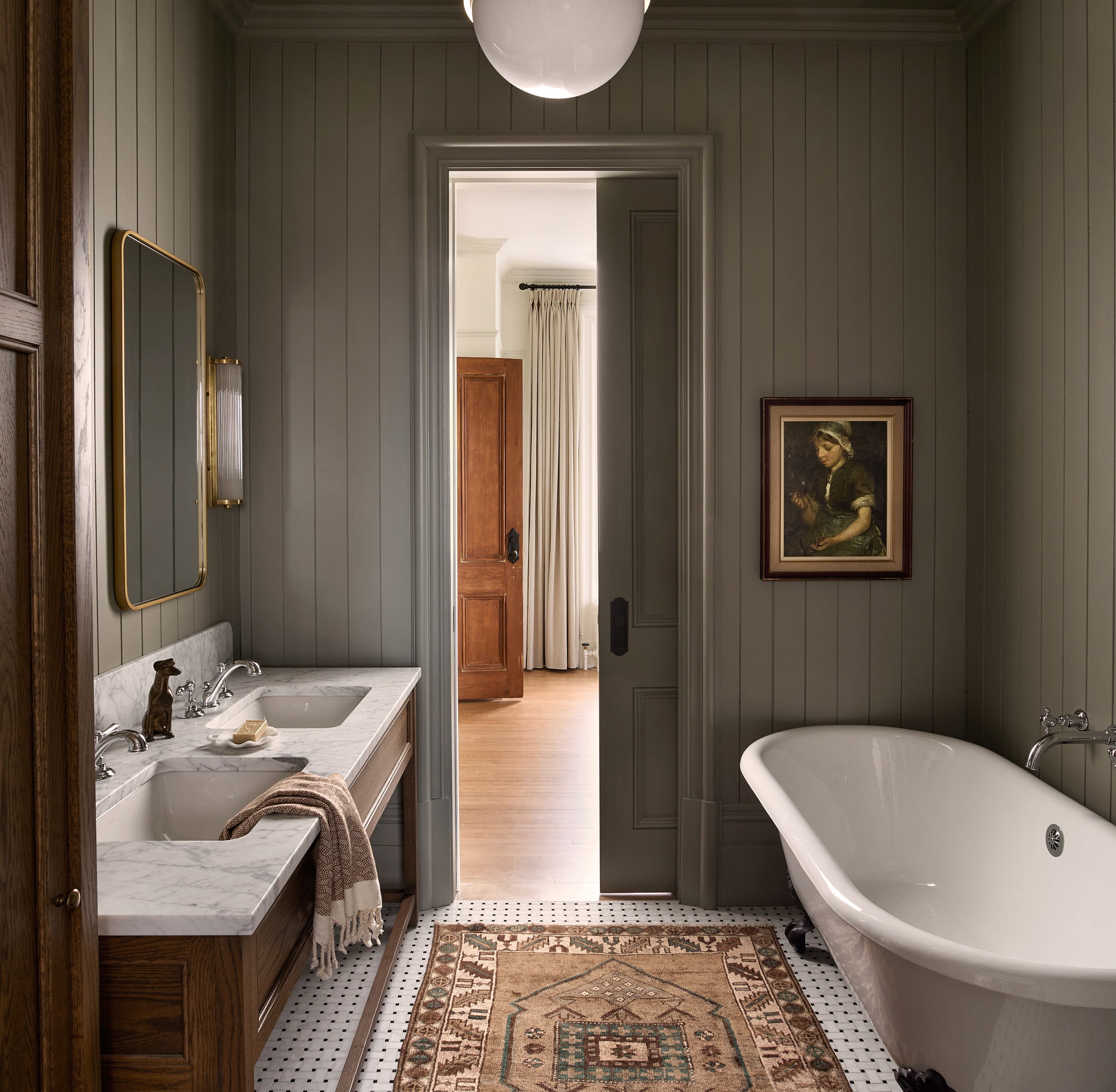 a bath room with a bath tub a sink and a rug