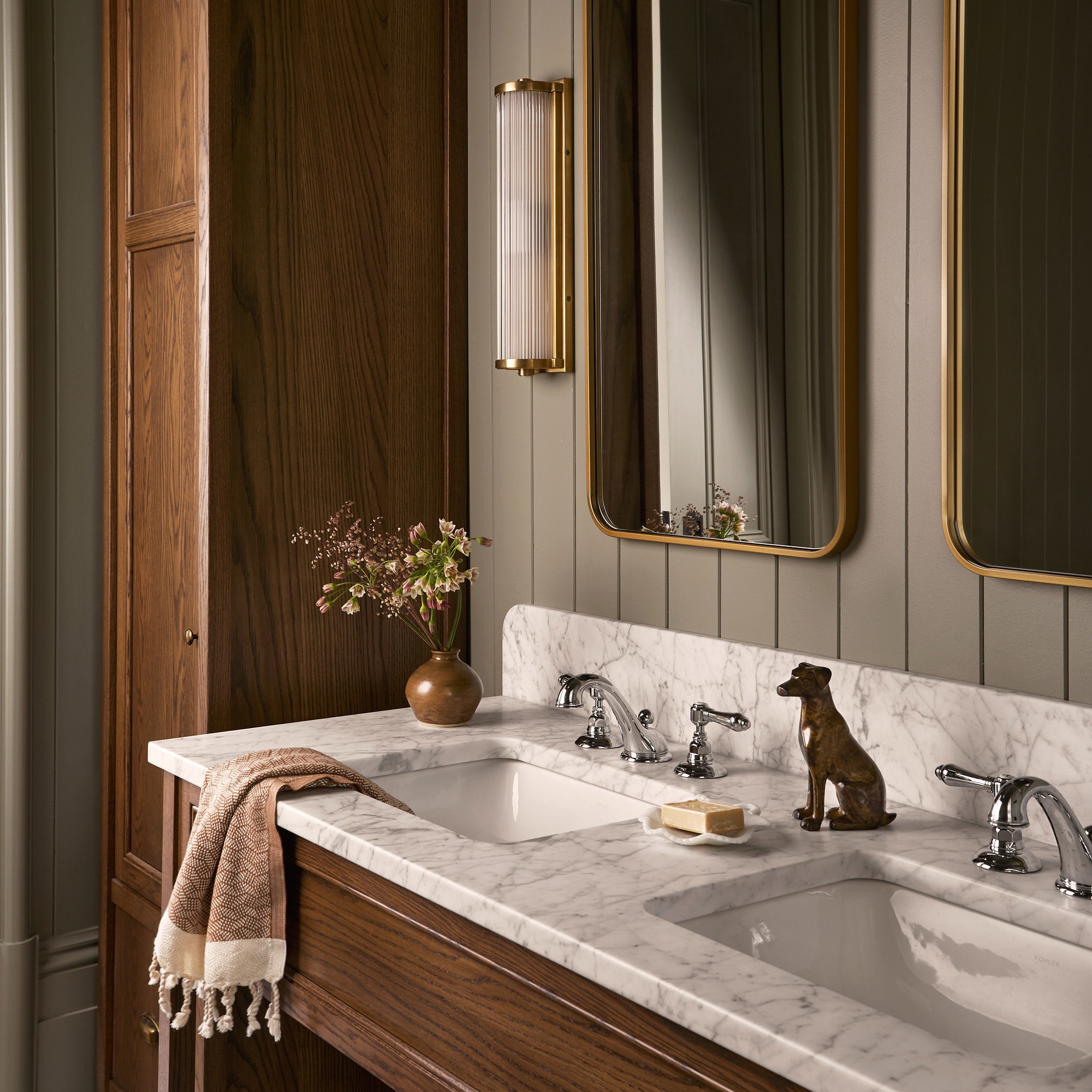 a bathroom with two sinks and a large mirror