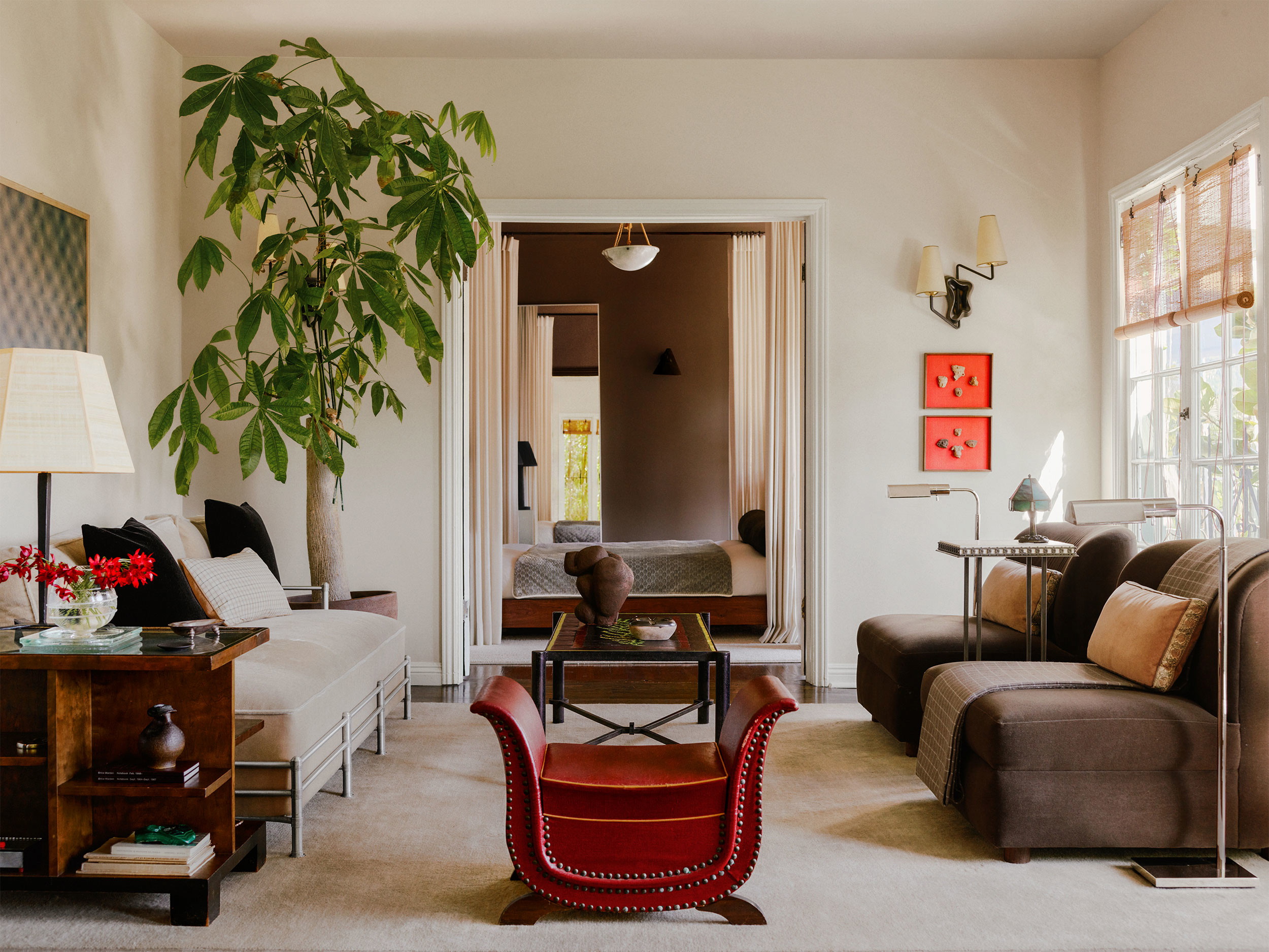 a living room filled with furniture and a potted plant