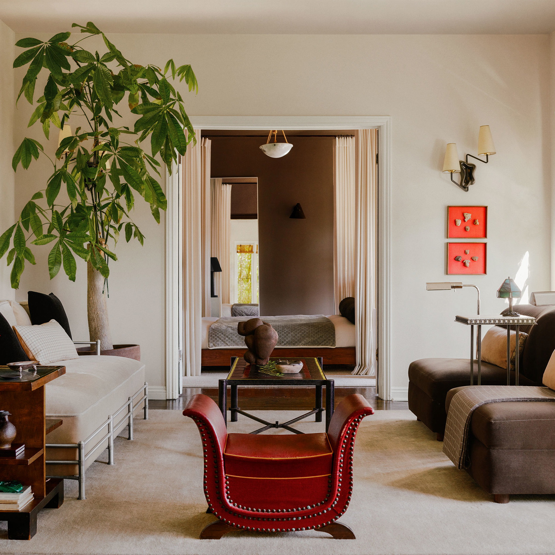 a living room filled with furniture and a potted plant