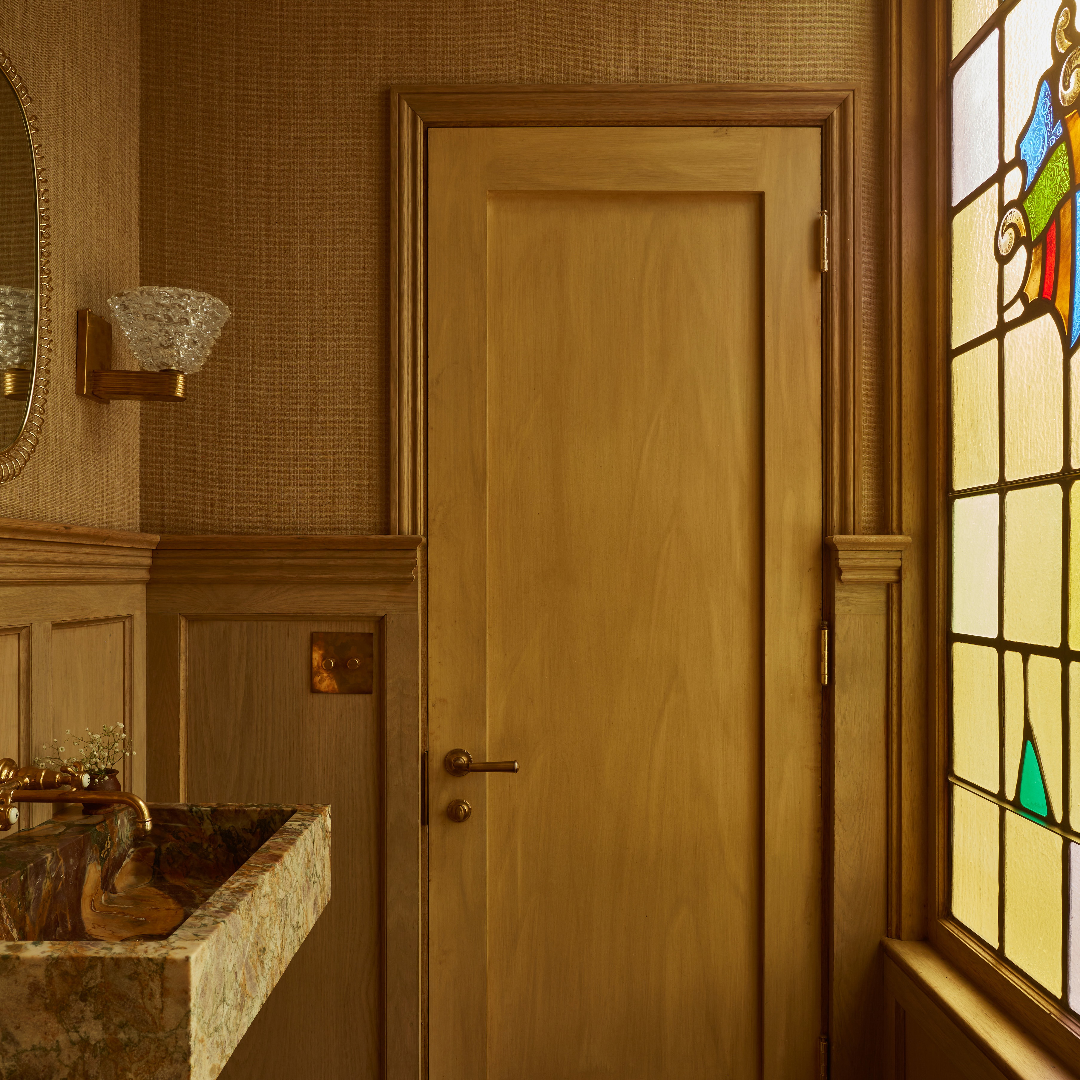 a bathroom with a sink and a stained glass window