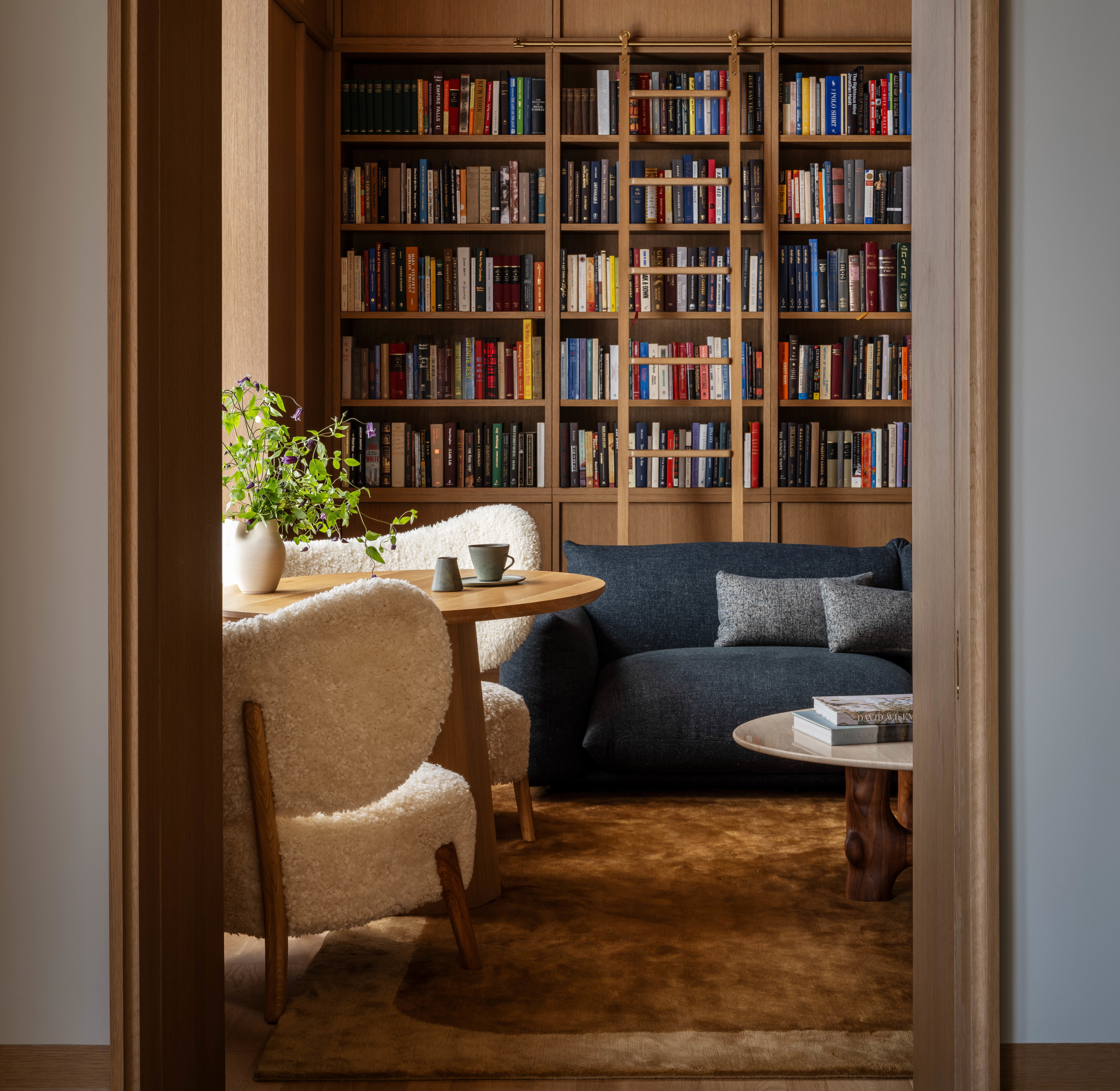 a living room filled with furniture and a book shelf