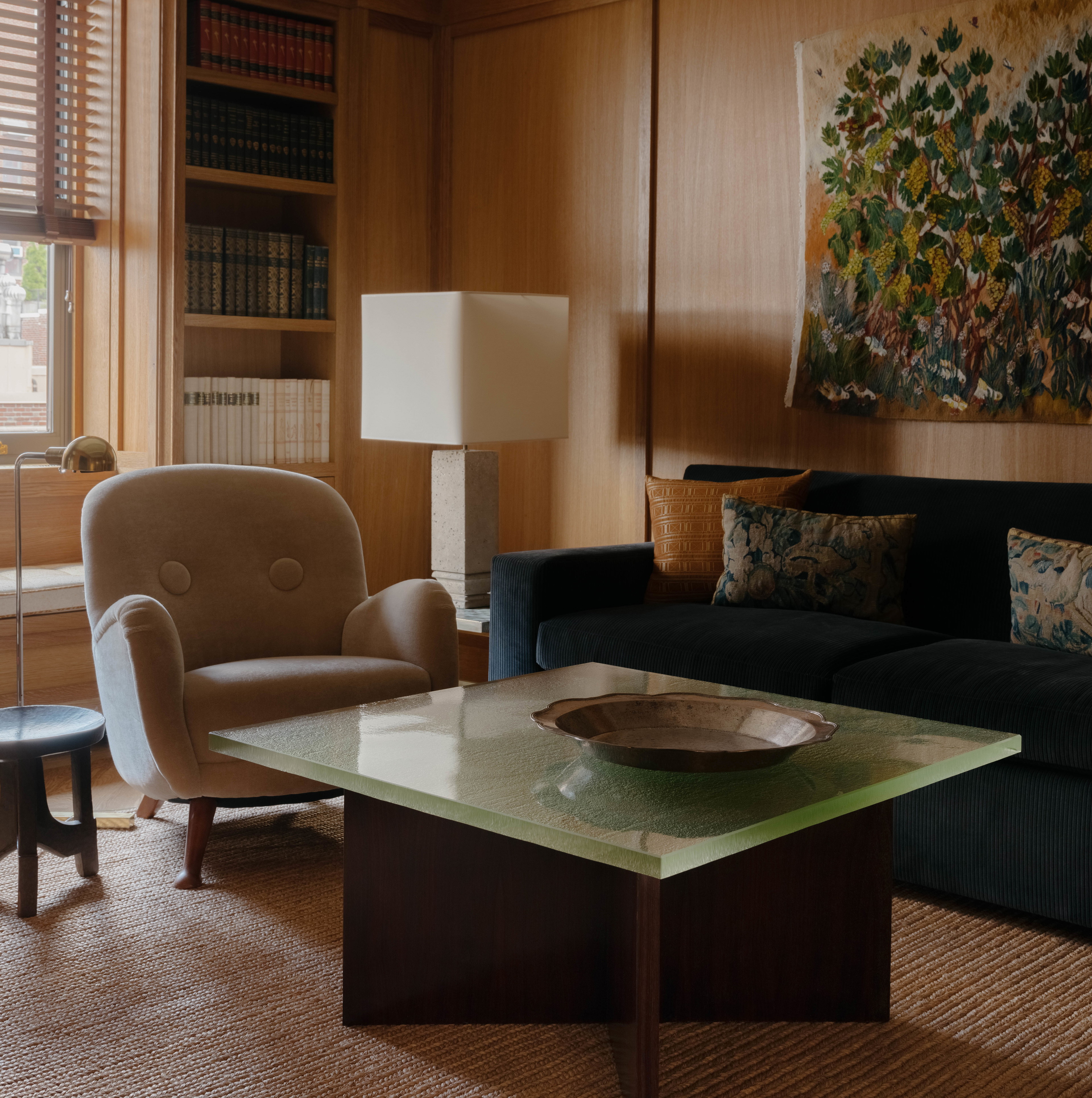 a living room filled with furniture and a painting on the wall