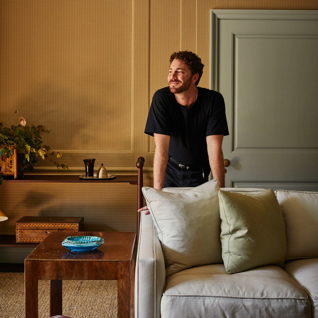 a man sitting on a couch in a living room