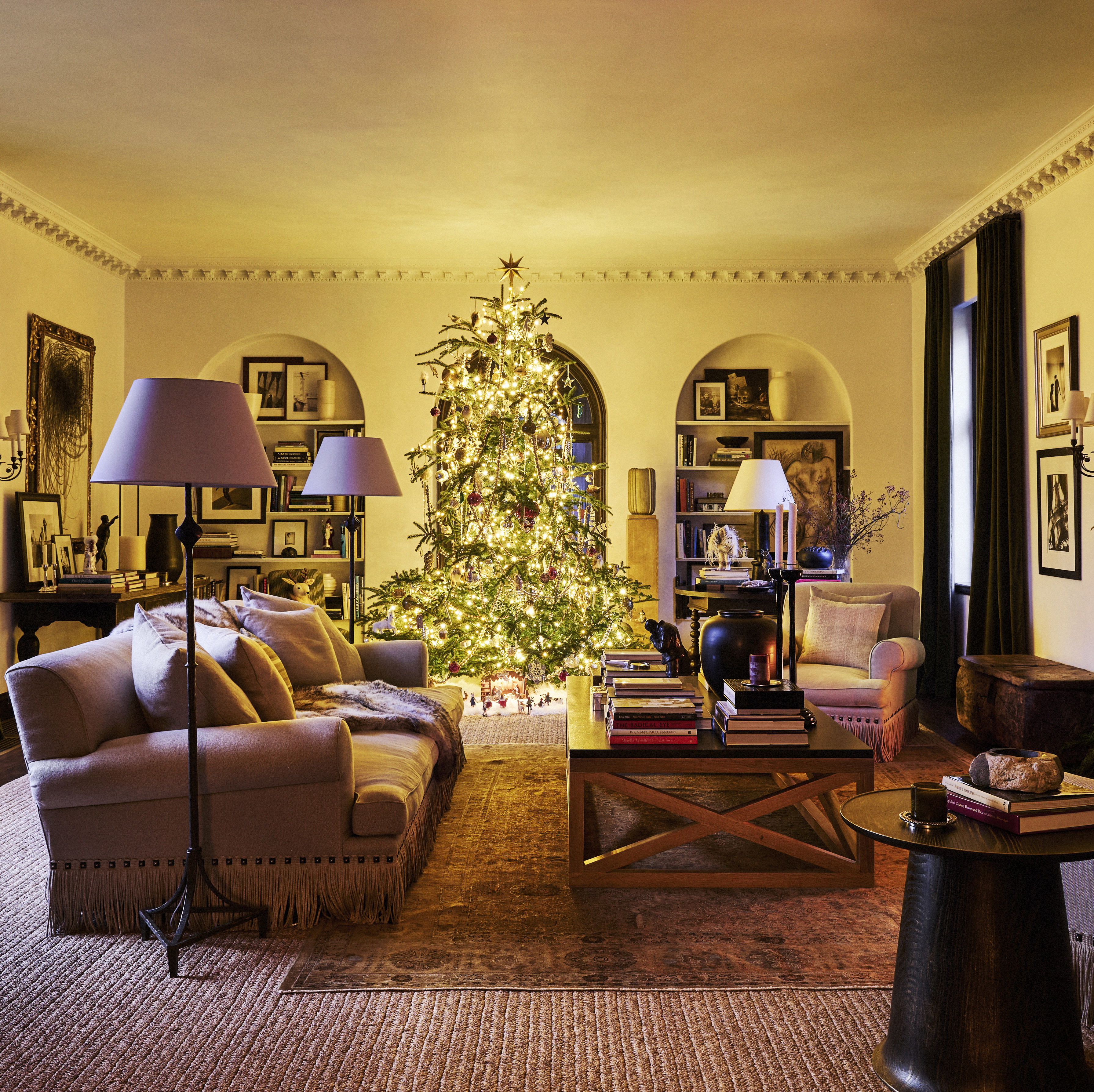 a living room filled with furniture and a christmas tree