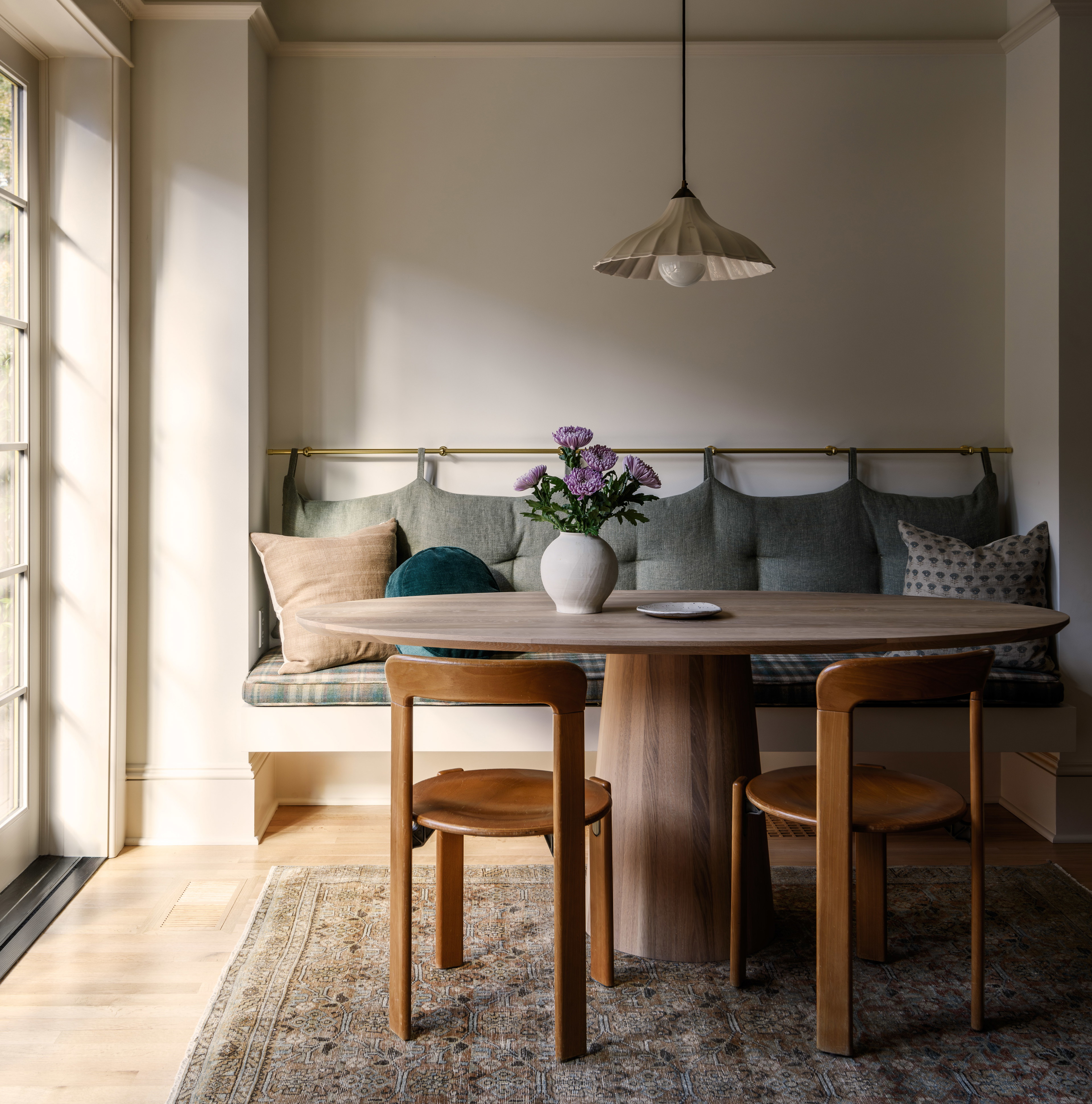 a room with a couch, table and chairs