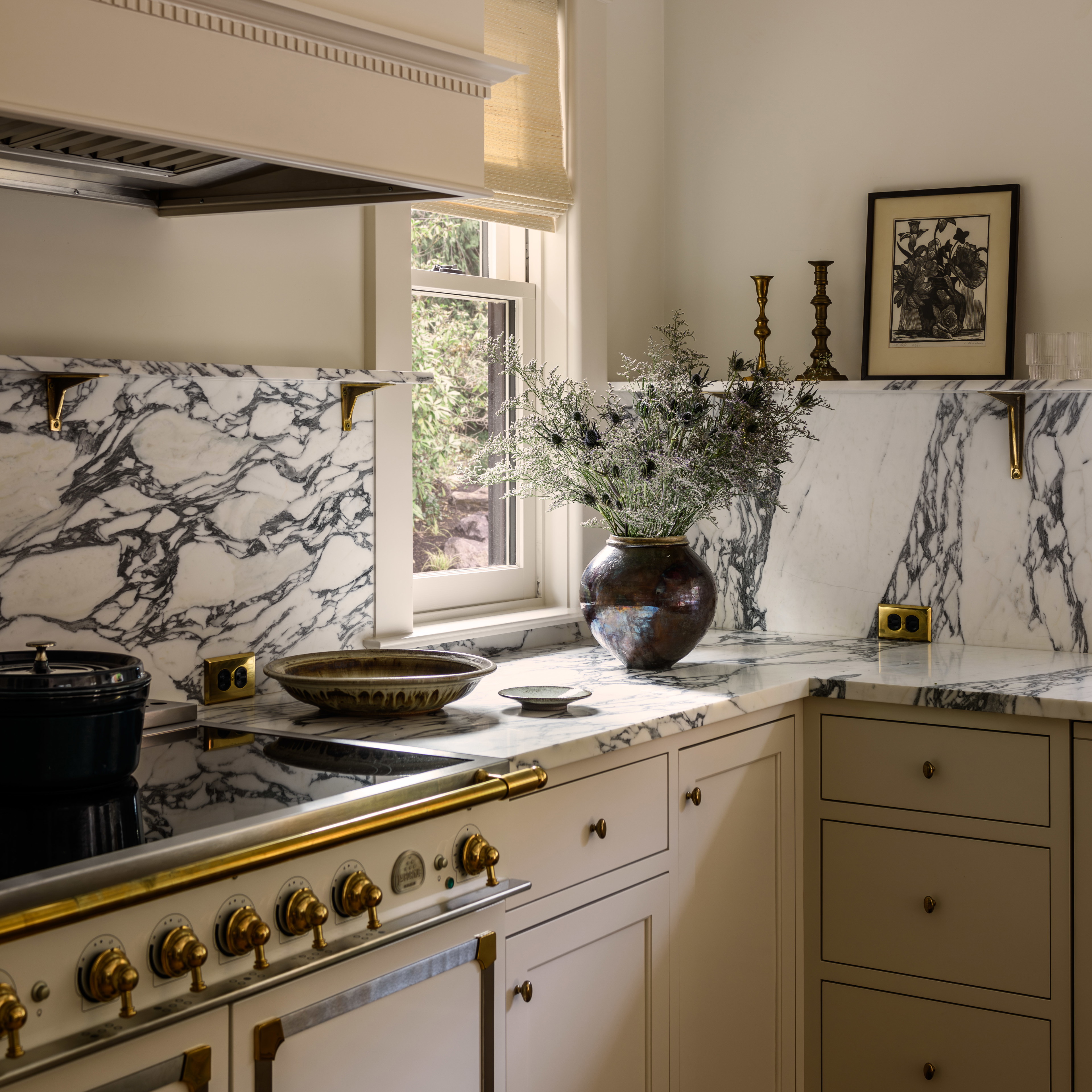 a kitchen with marble counter tops and gold trim