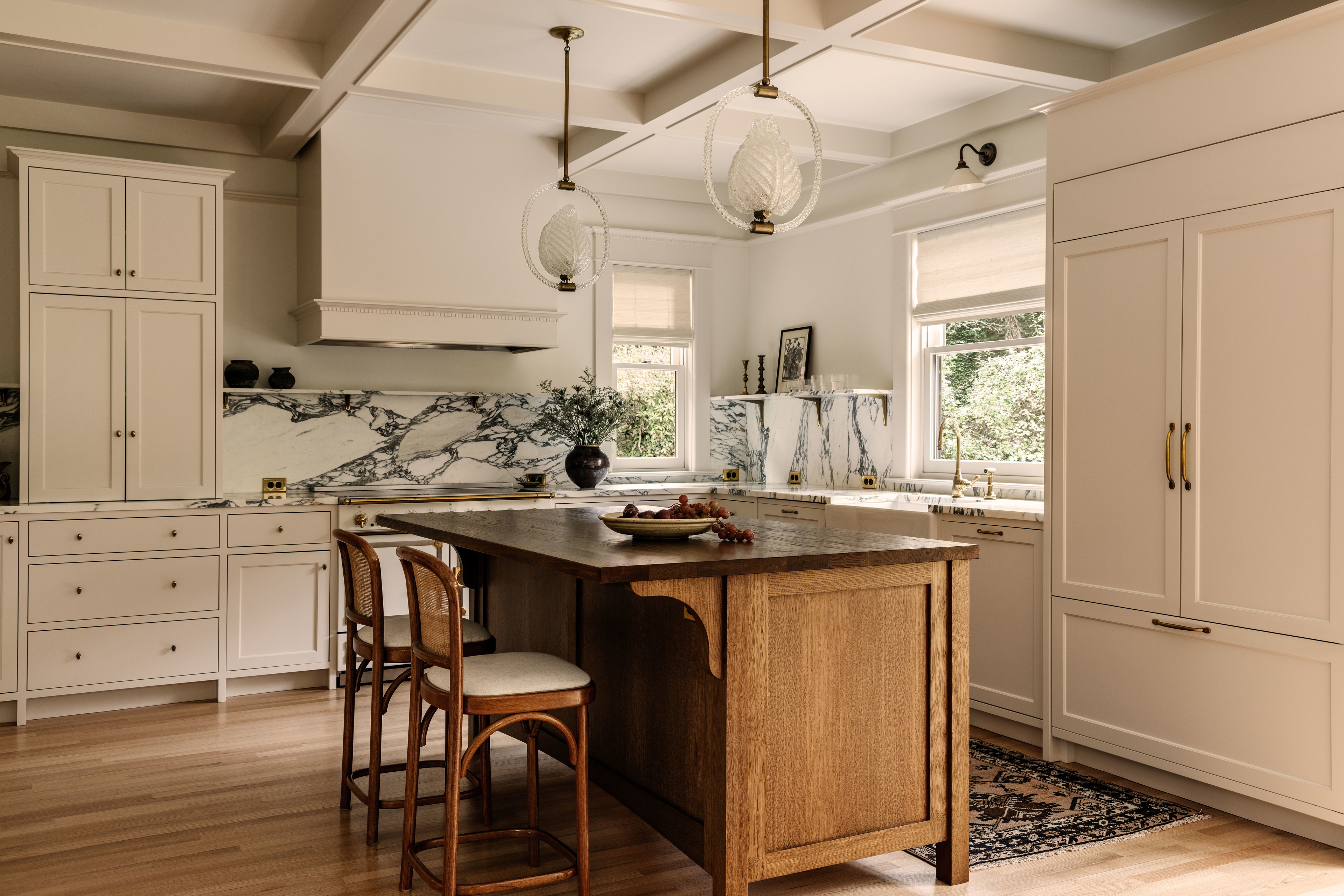 a kitchen with a center island and two stools