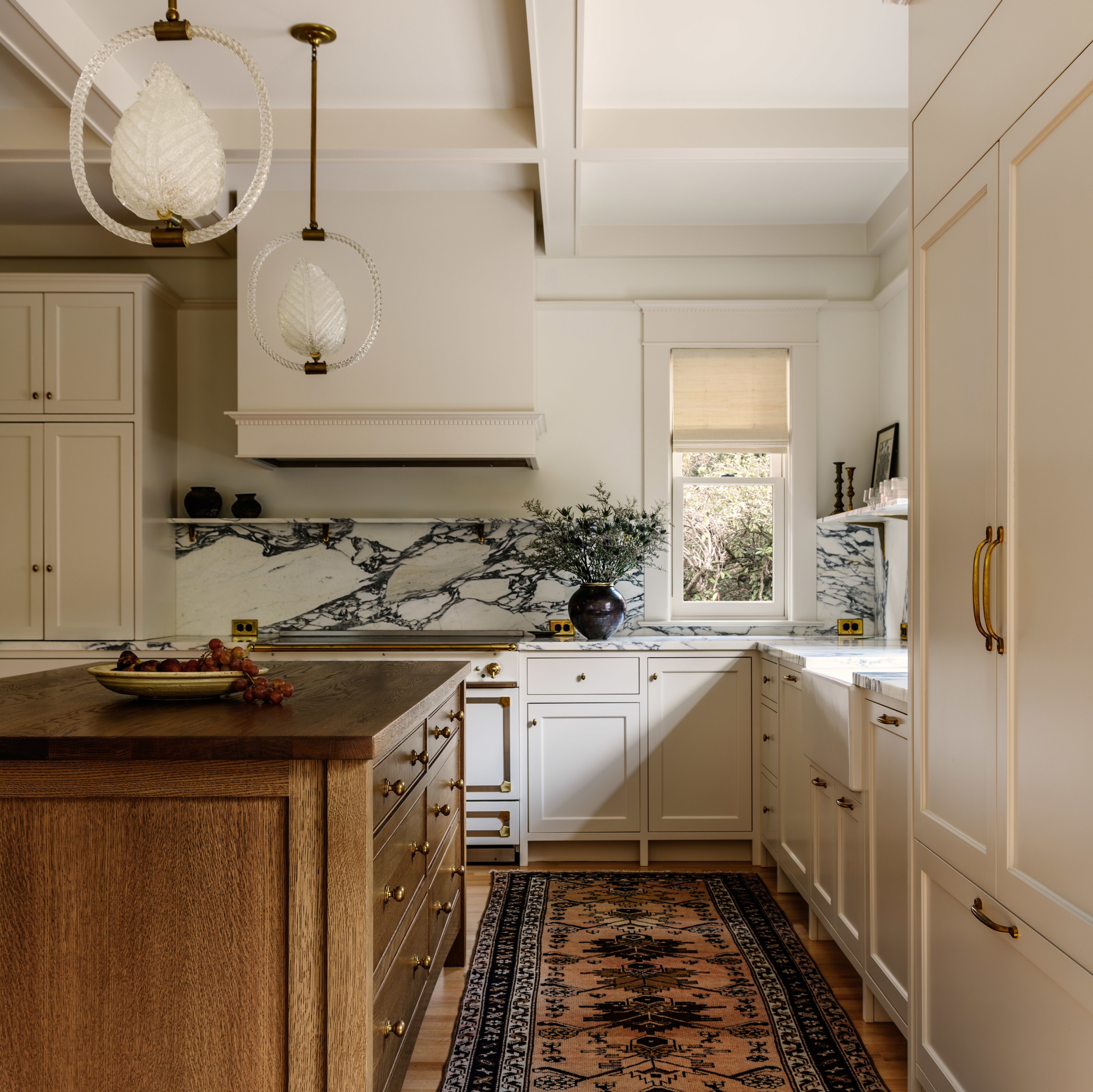 a kitchen with a rug in the middle of the floor