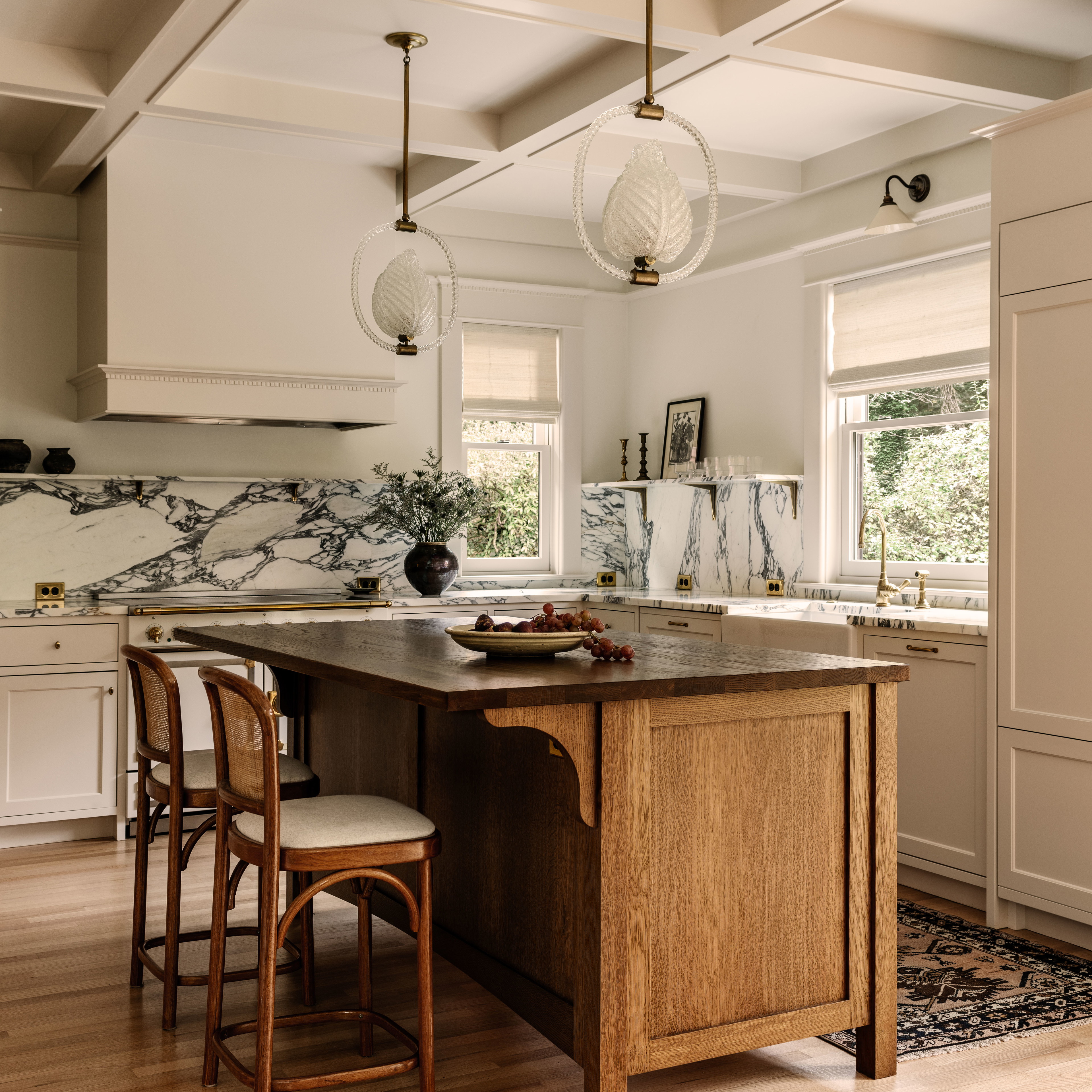 a kitchen with a center island and two stools