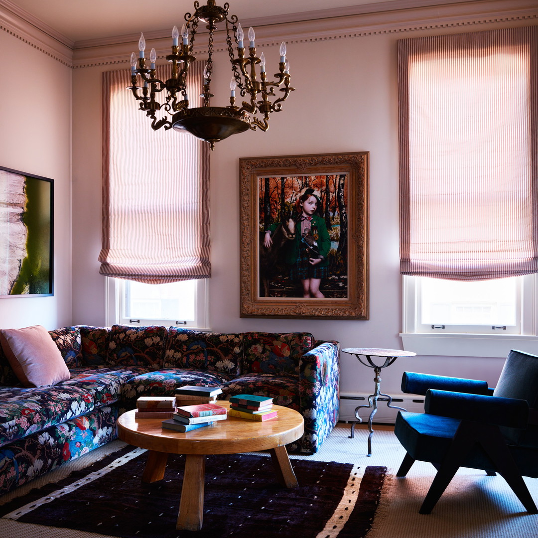 a living room filled with furniture and a chandelier