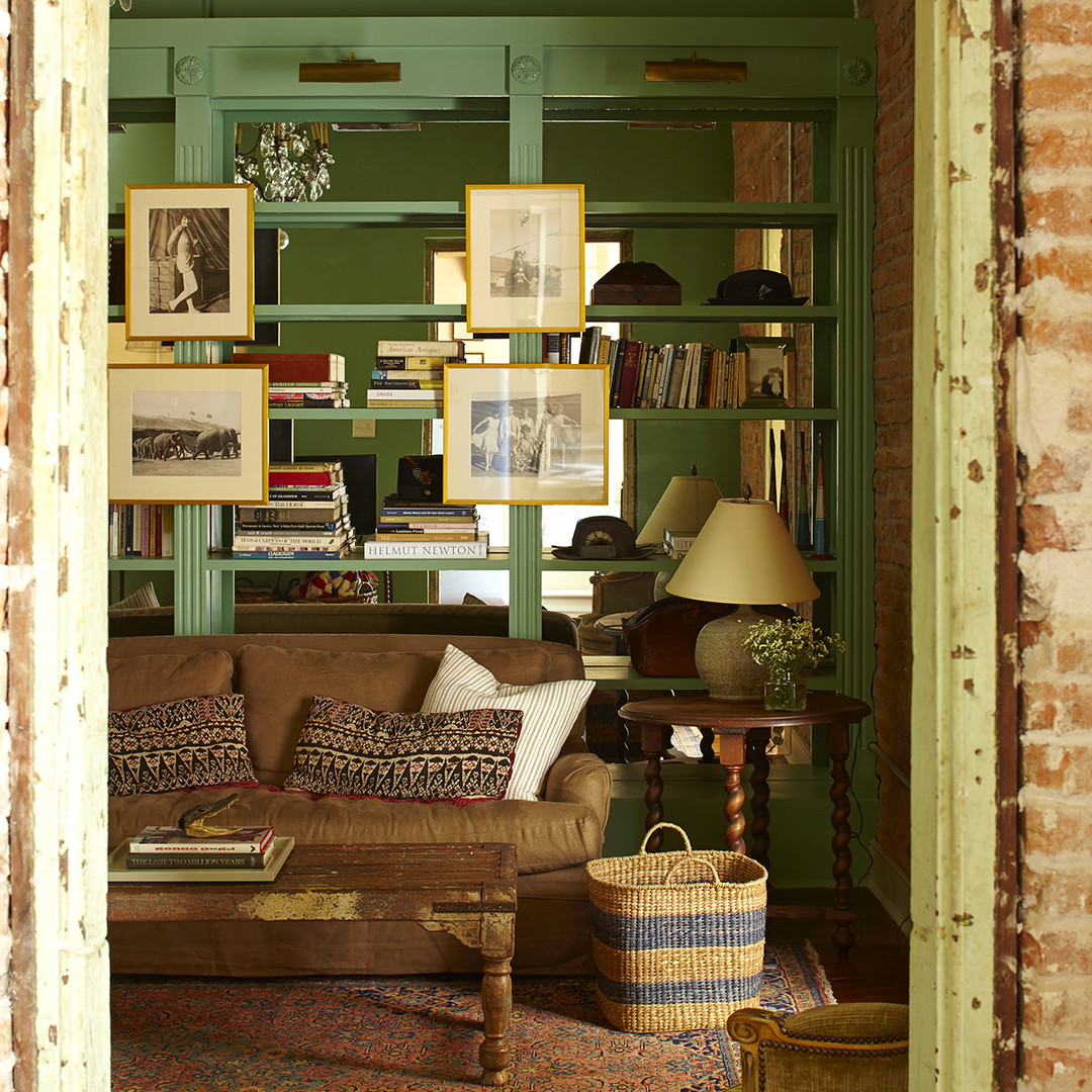 a living room filled with furniture and lots of books