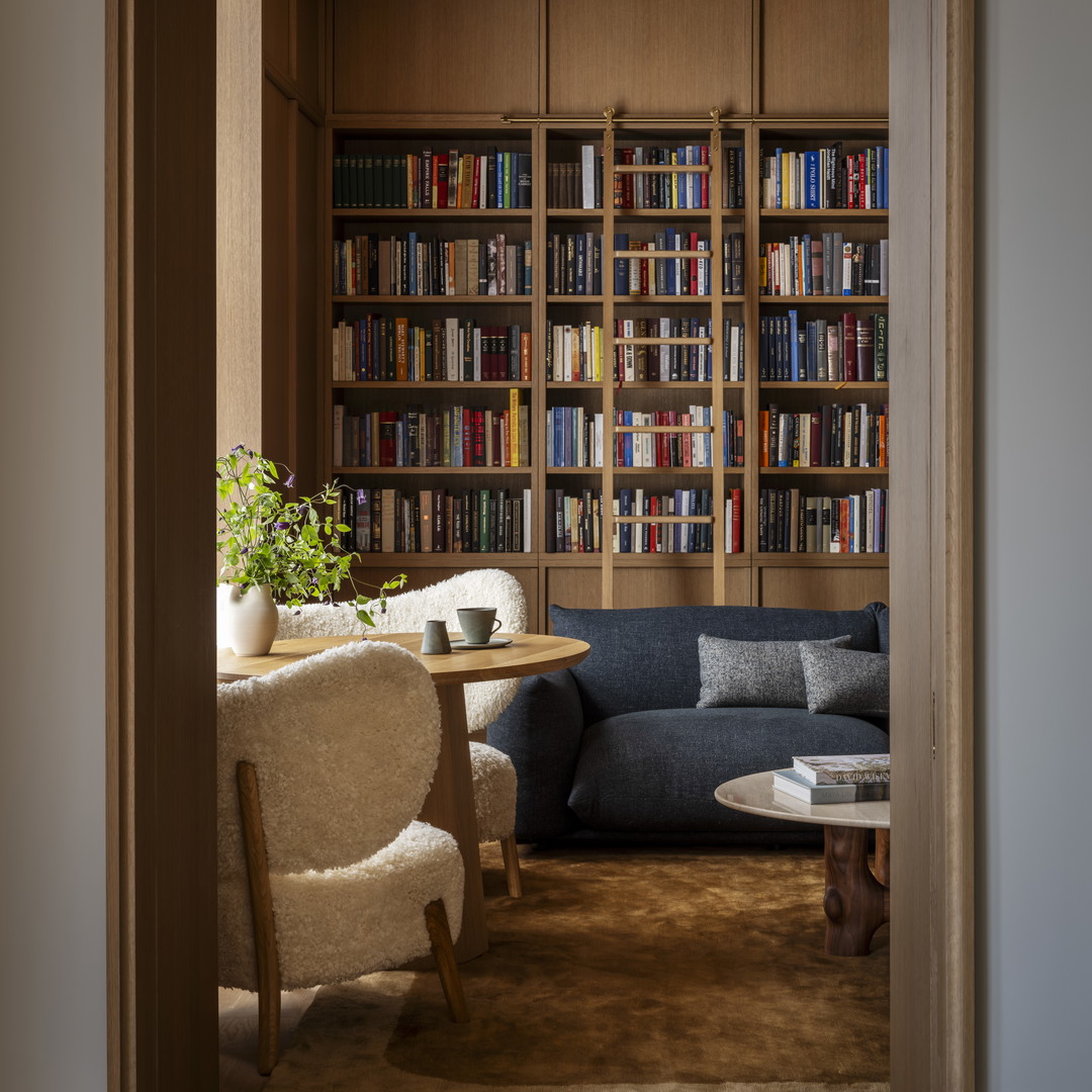 a living room filled with furniture and a book shelf