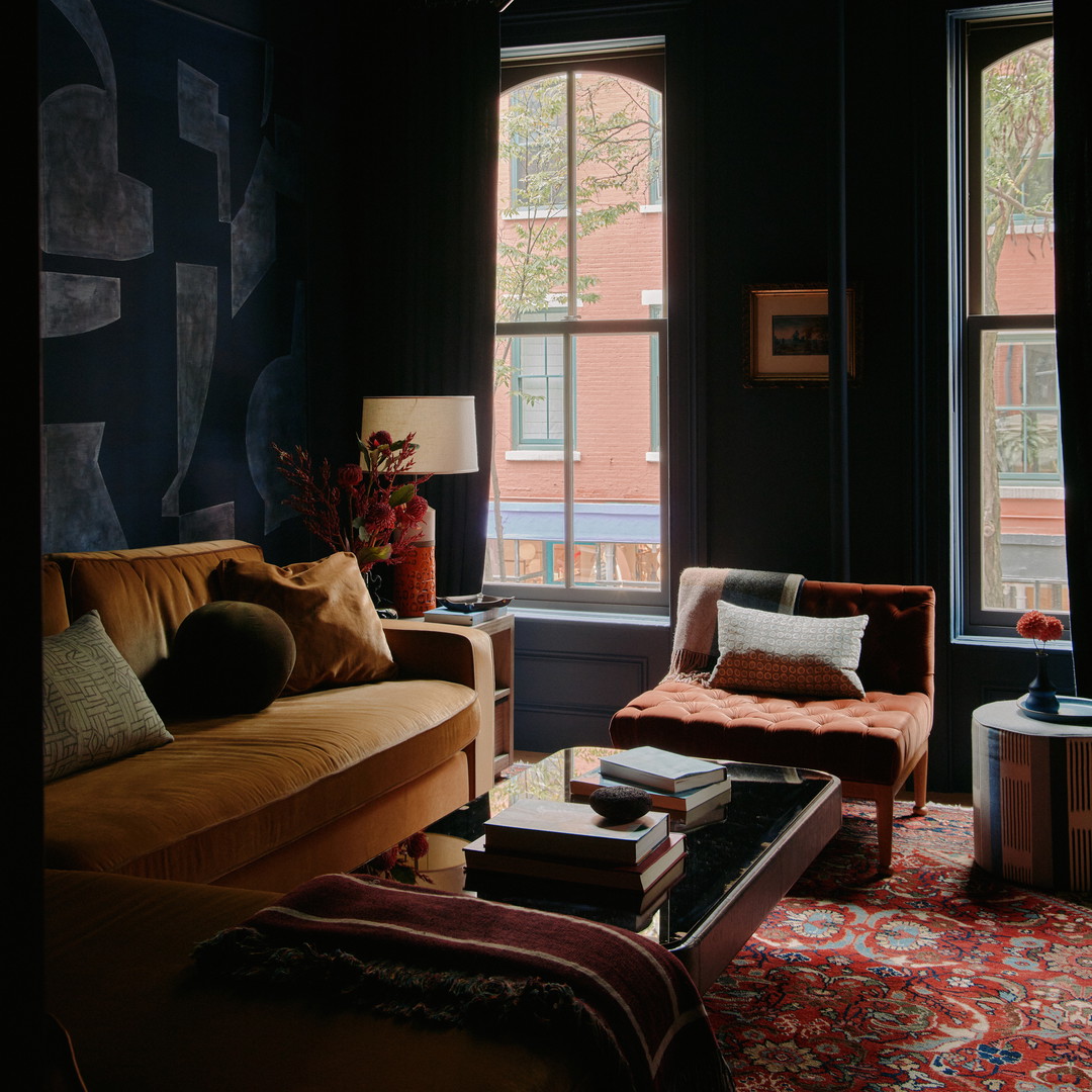 a living room filled with furniture and a large window