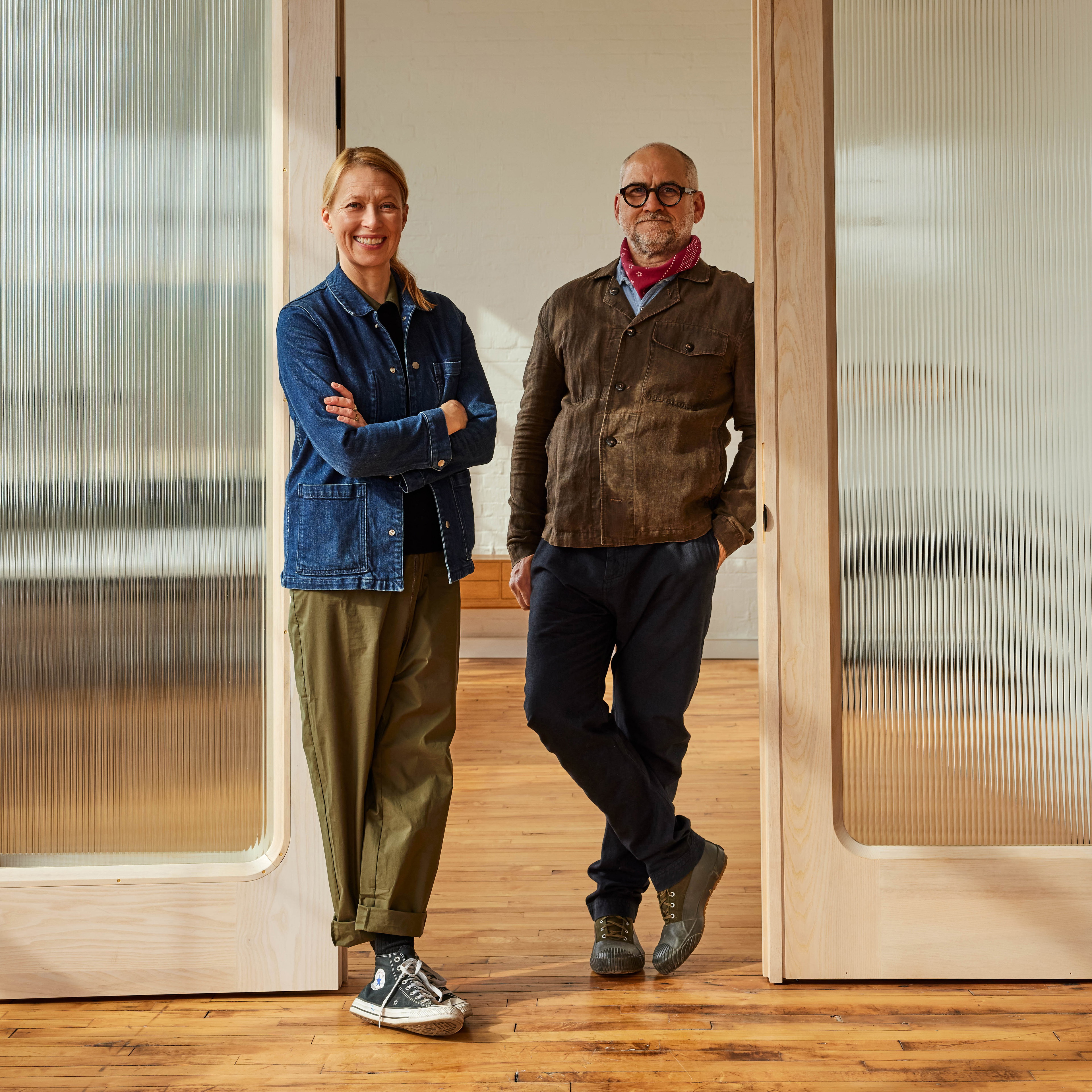 a couple of people standing in front of some doors