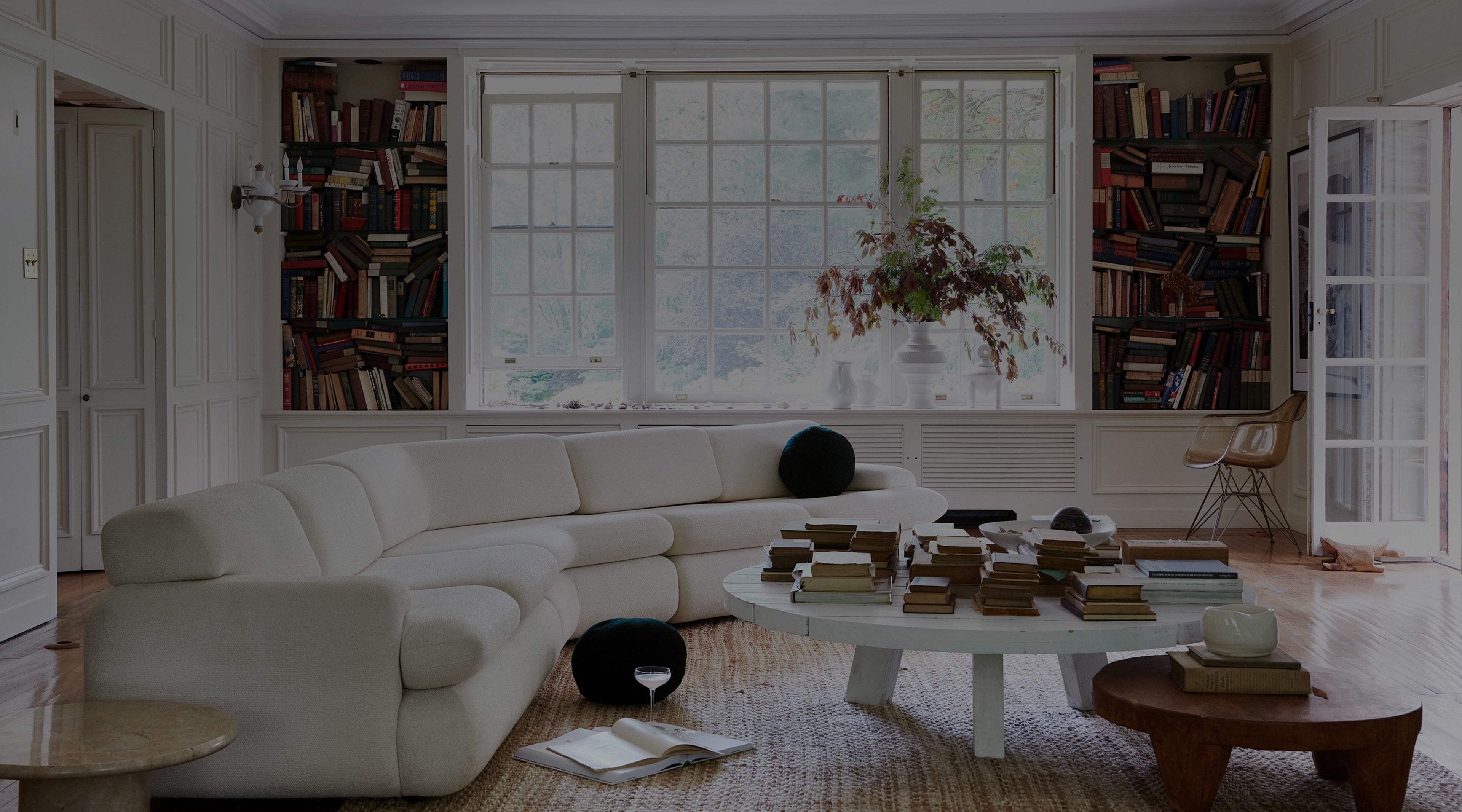 a living room filled with furniture and a large window