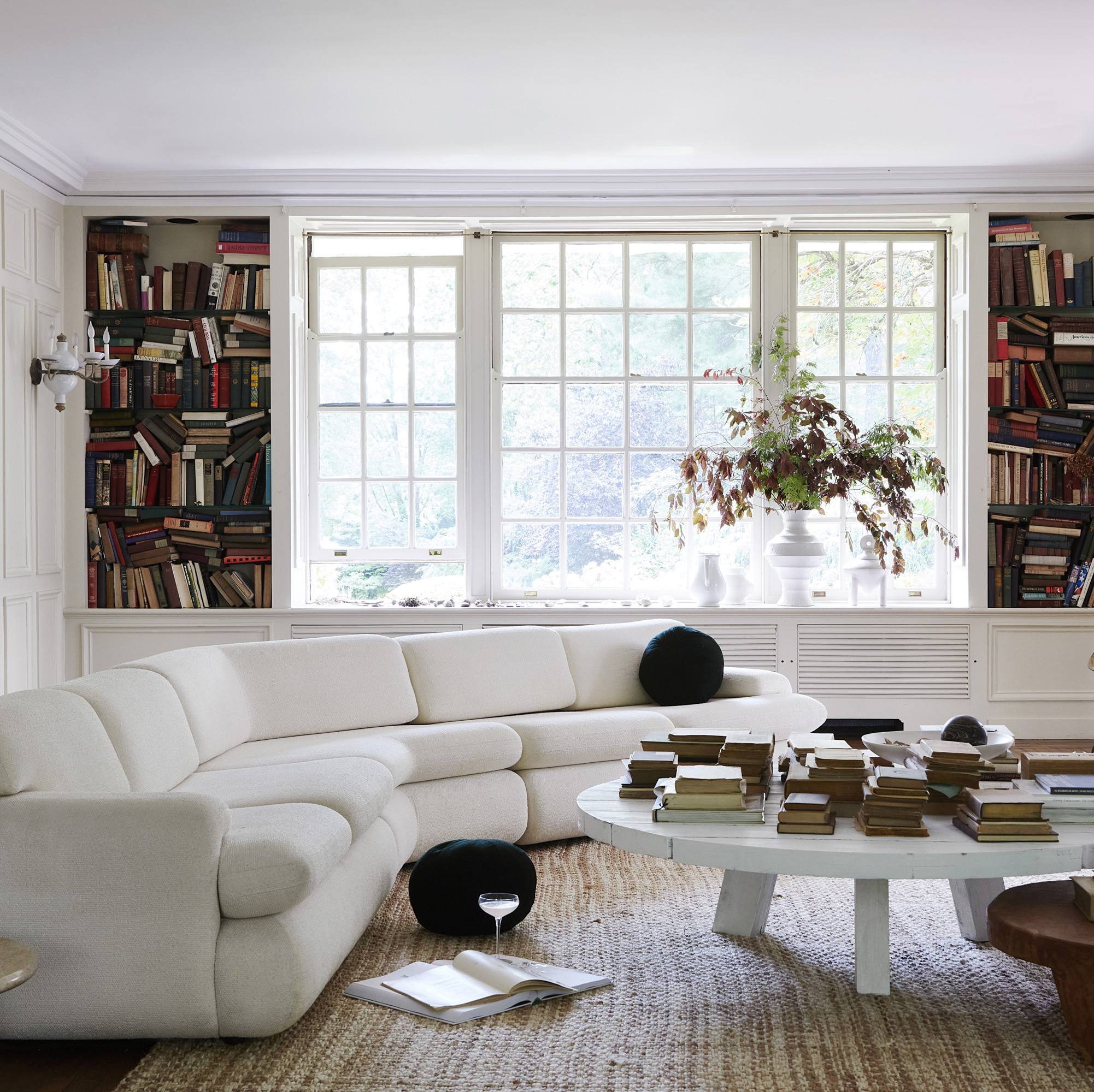 a living room filled with furniture and a large window