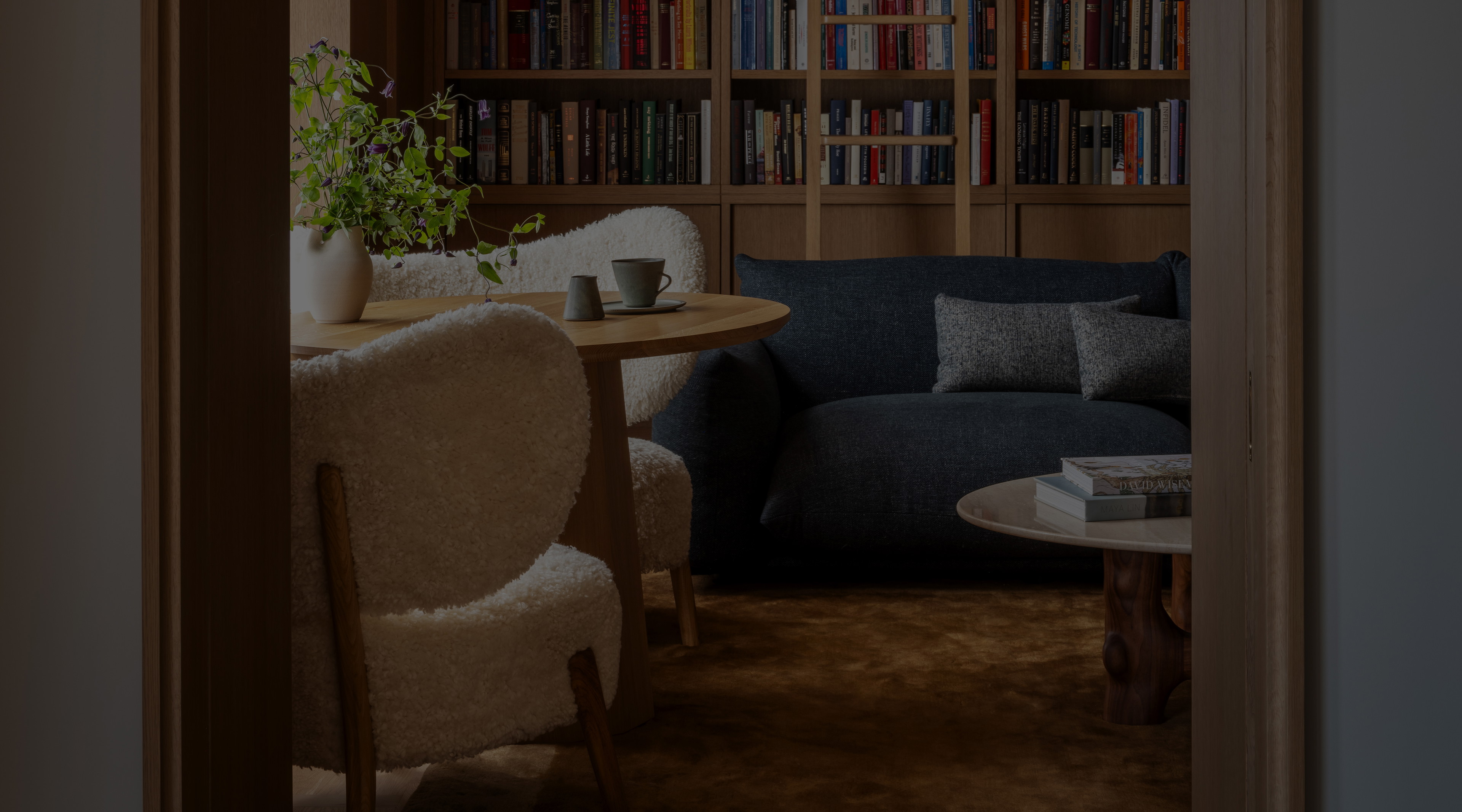 a living room filled with furniture and a book shelf