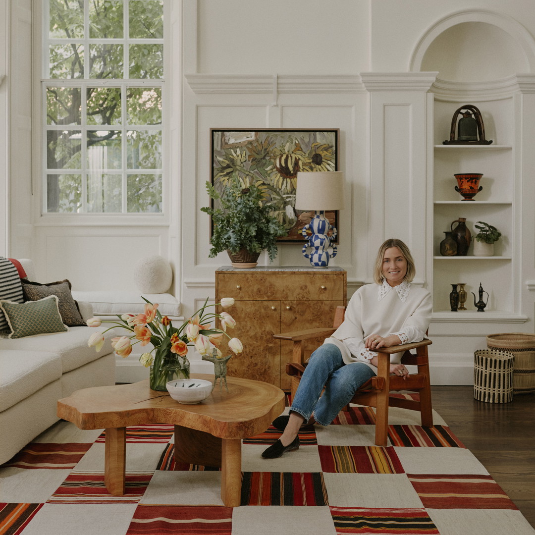 a woman sitting in a chair in a living room