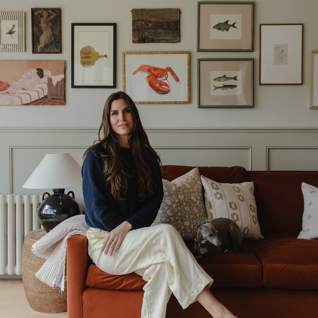 a woman sitting on a couch in a living room