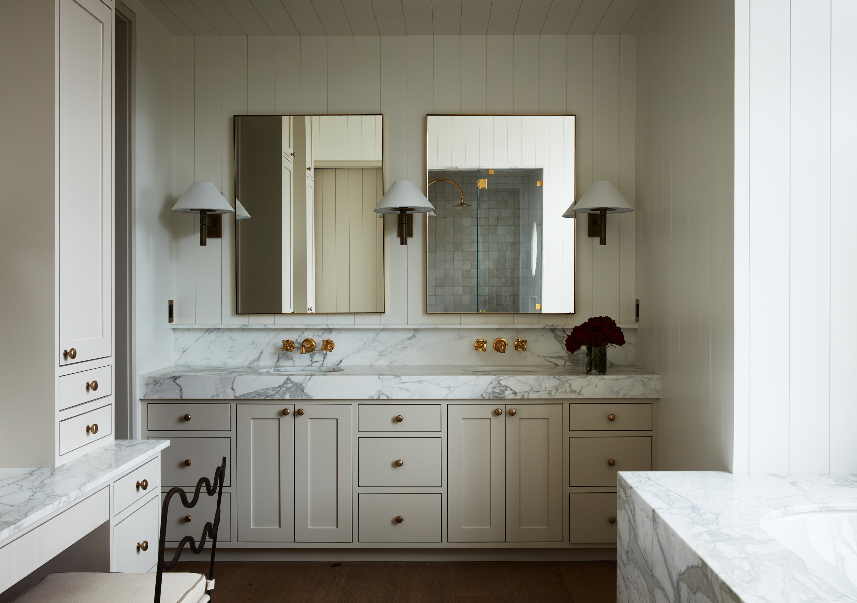 a bathroom with two sinks and two mirrors