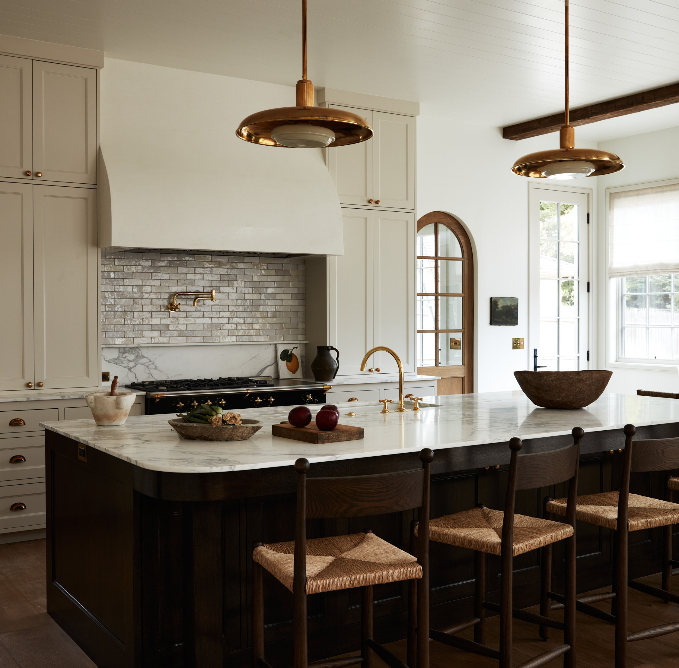 a large kitchen with a center island with chairs