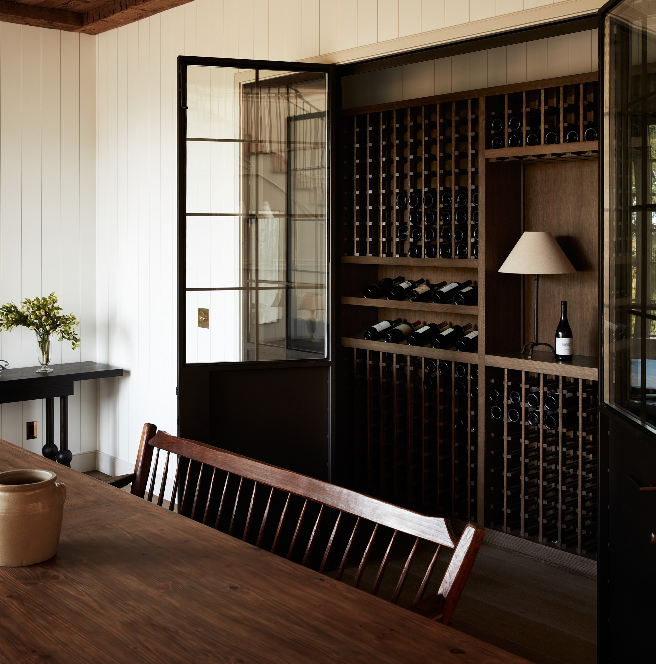 a dining room with a table and a wine rack