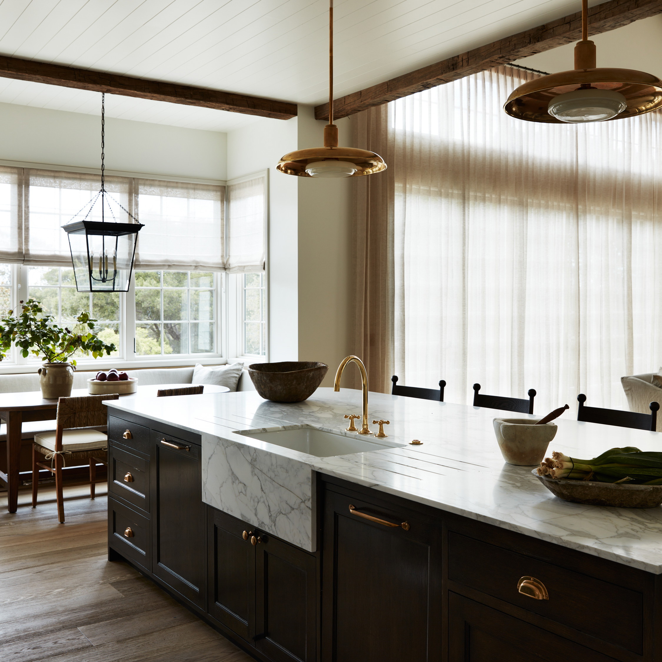 a kitchen with a marble counter top and wooden cabinets