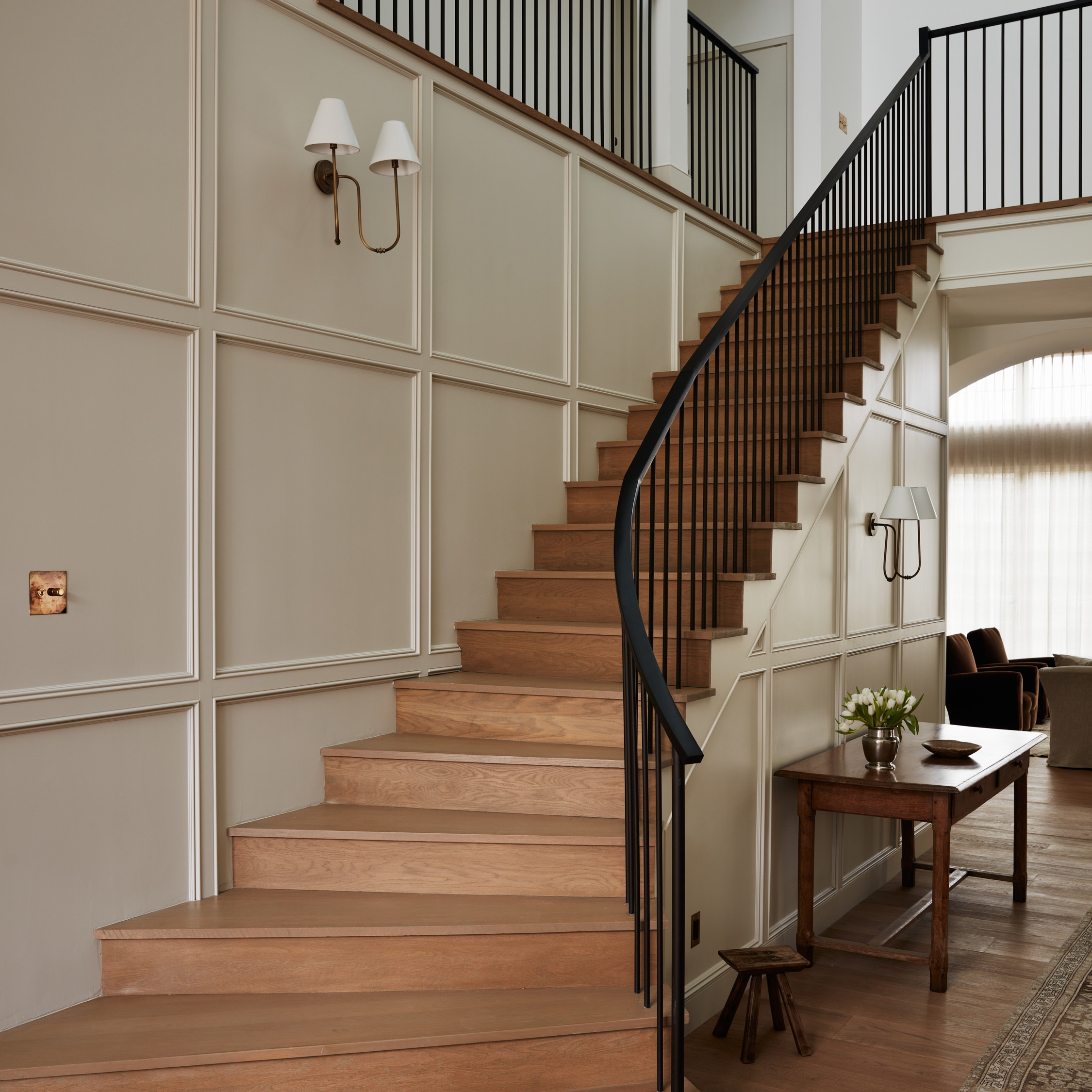 a living room filled with furniture and a stair case