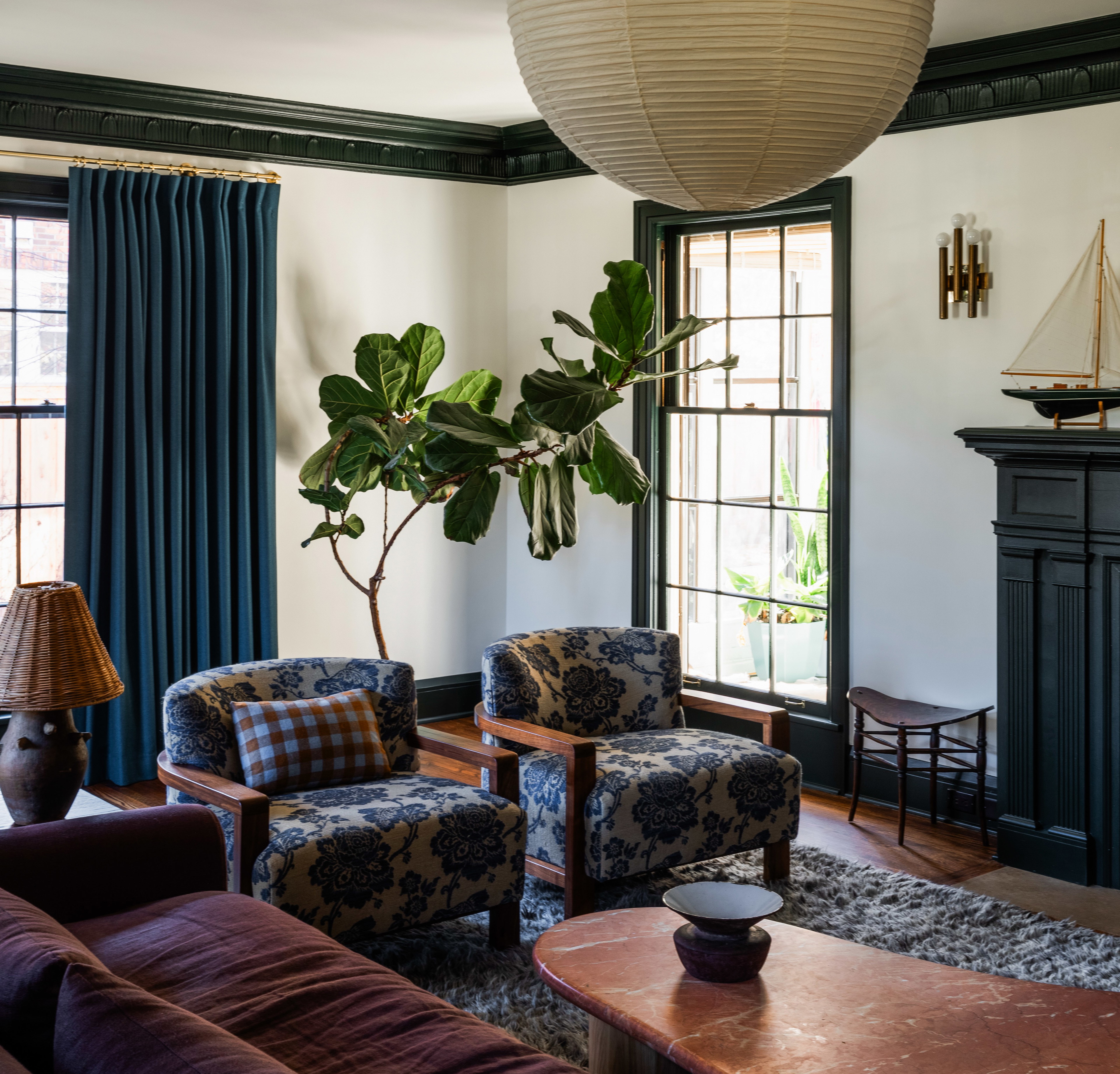 a living room filled with furniture and a potted plant