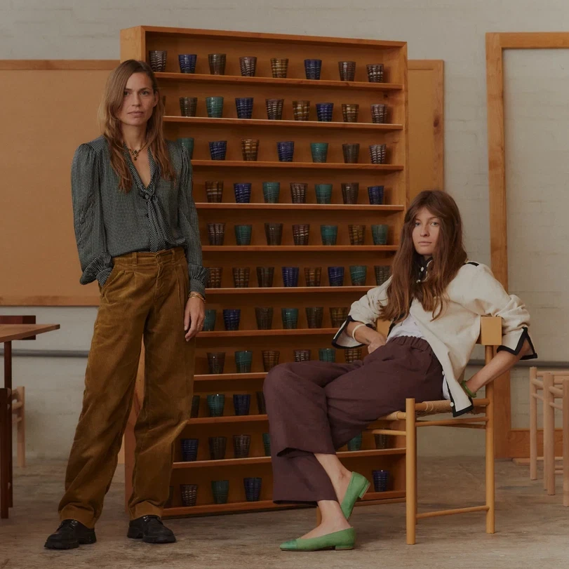 two women sitting in chairs in a room