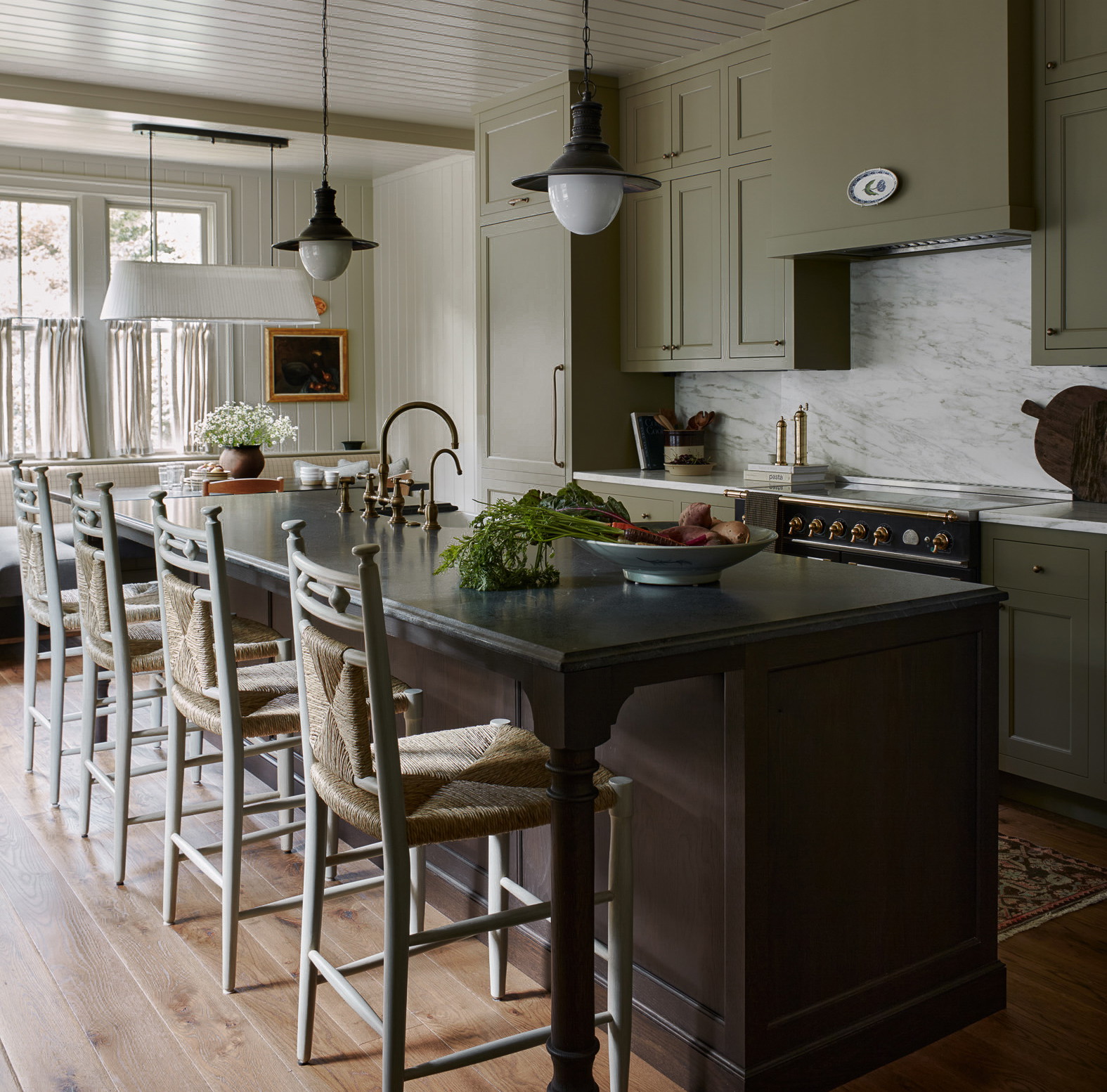 a kitchen with a center island with chairs