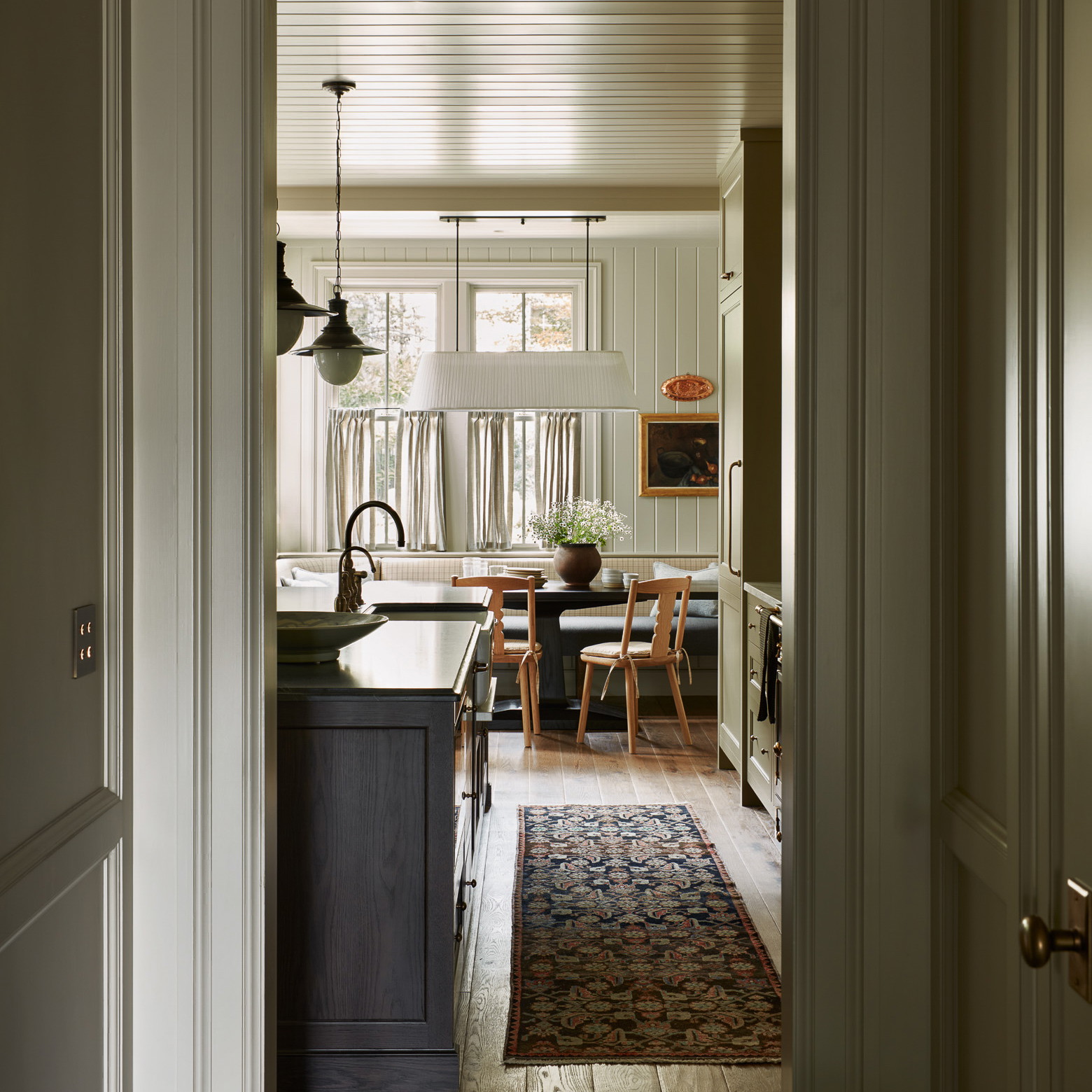 an open door leading to a kitchen and dining room