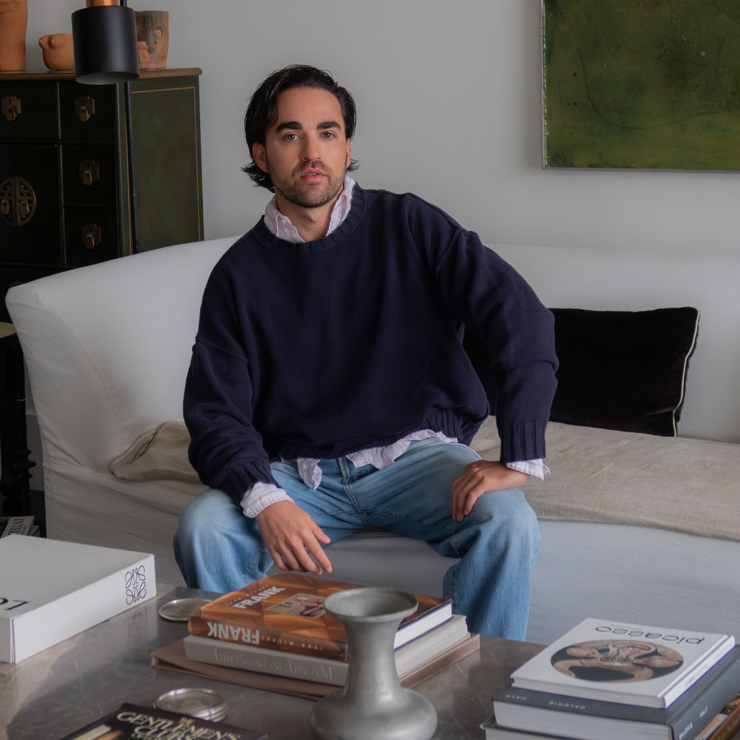 a man sitting on a couch in a living room