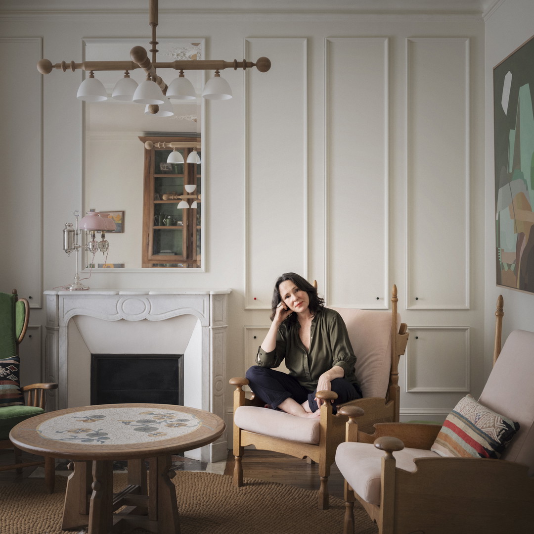 a woman sitting in a chair in a living room